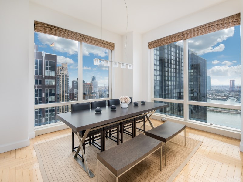 845 United Nations Plaza, Unit 33A Manhattan, NY 10017 - Photo 4 of 10 a dining room with furniture and wooden floor