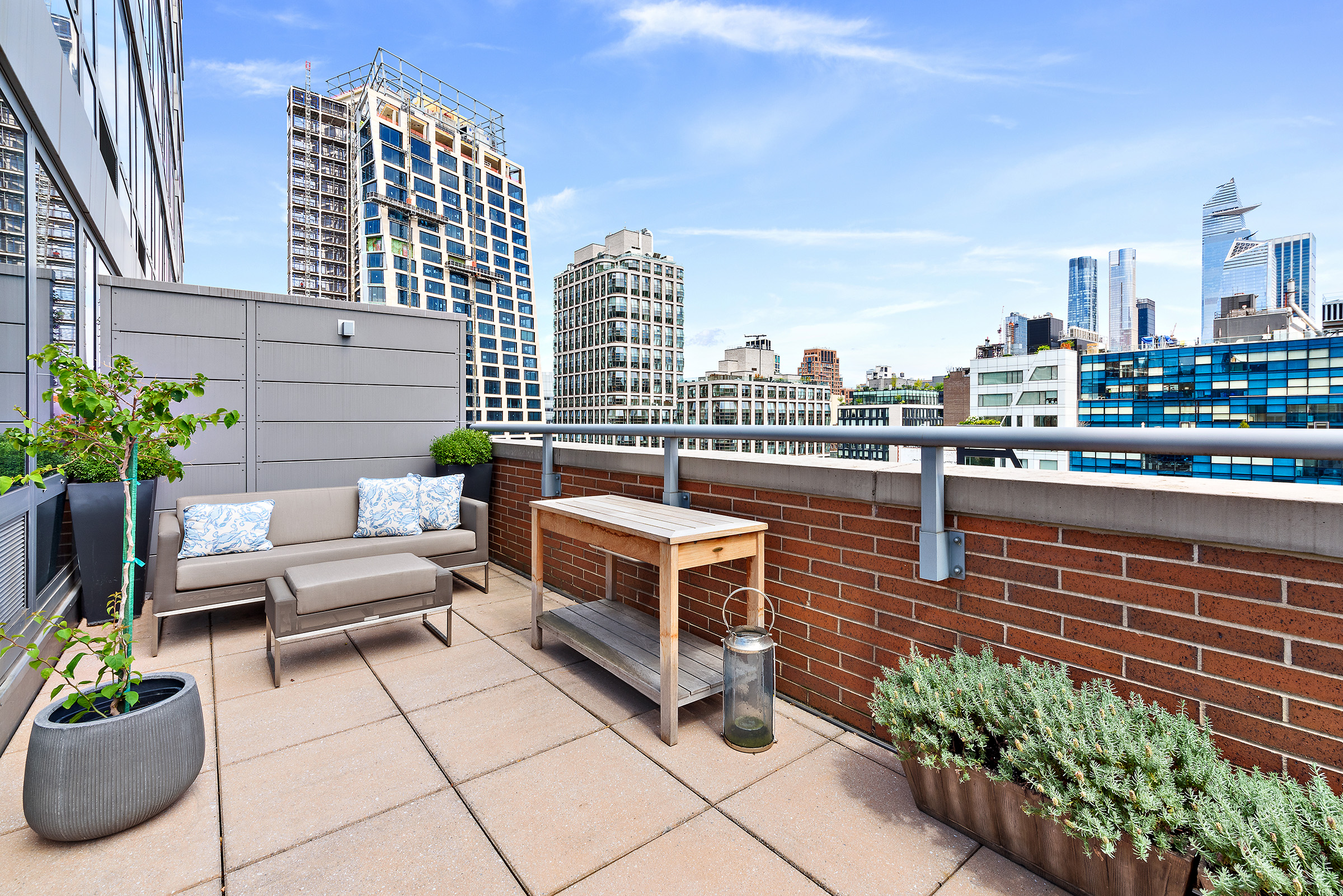 450 West 17th Street, Unit 1003 Manhattan, NY 10011 - Photo 2 of 9 a roof deck with couch and potted plants