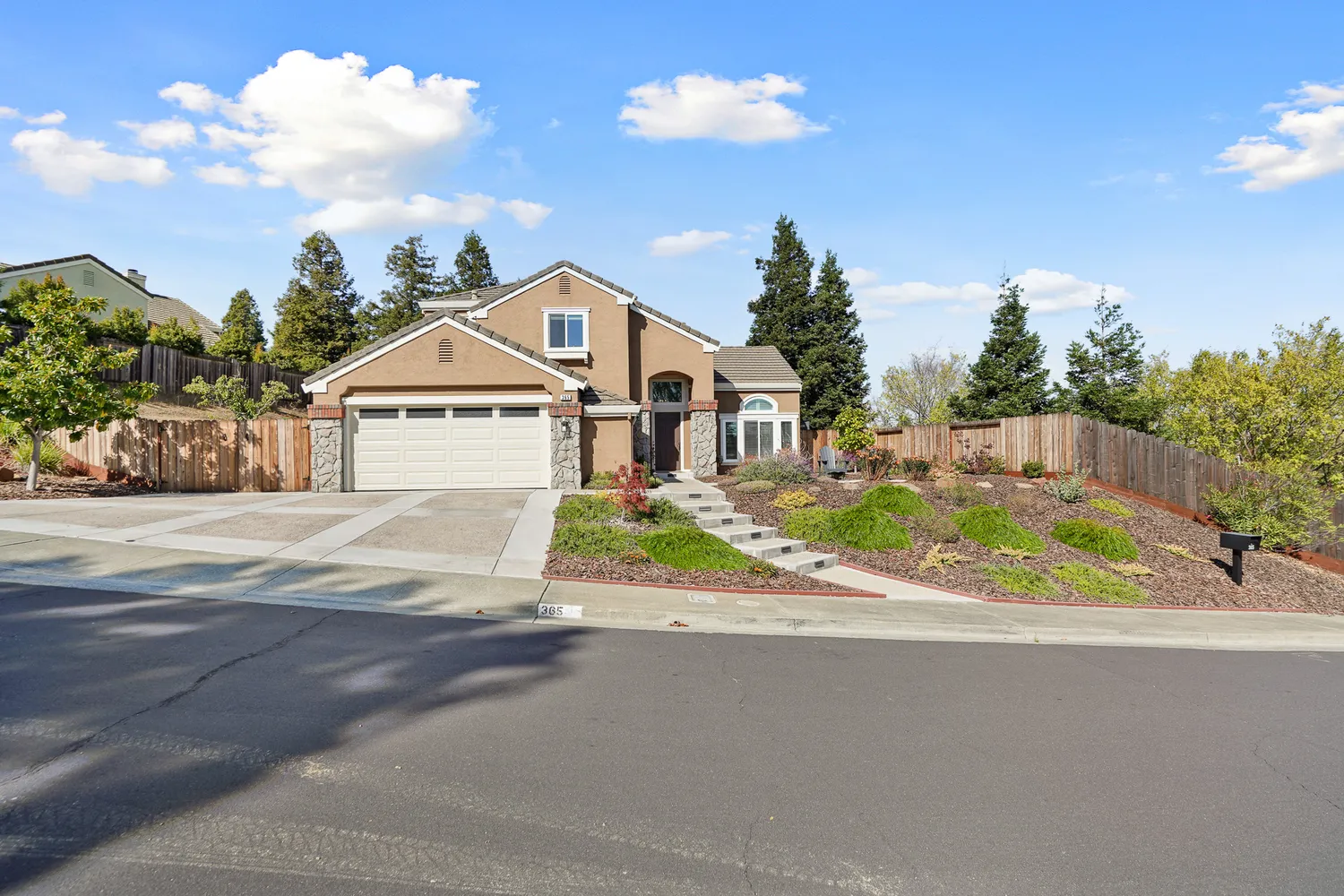 a view of a house with a yard and street view
