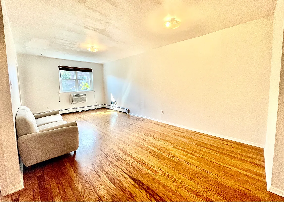 25-92 36th Street, Unit 2 Queens, NY 11103 - Photo 5 of 7 a living room with a furniture and a wooden floor