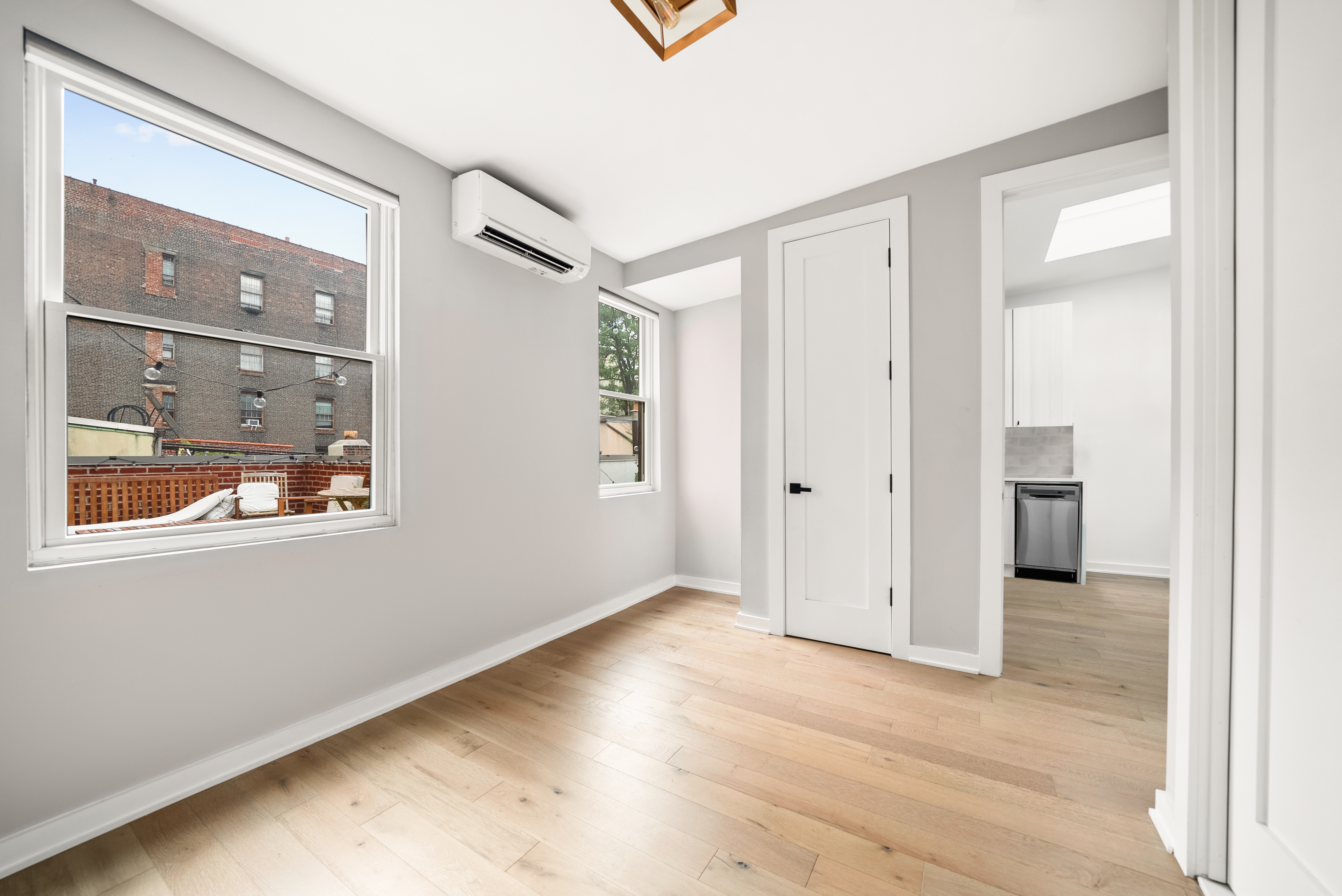 275 Bleecker Street, Unit 4 Manhattan, NY 10014 - Photo 1 of 10 an empty room with wooden floor and a window