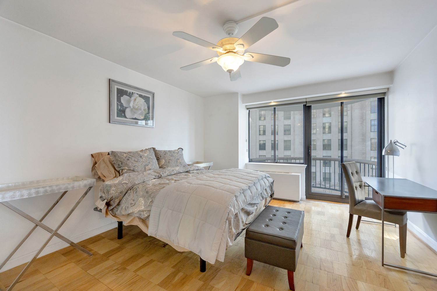 a living room with a bed furniture and a large window