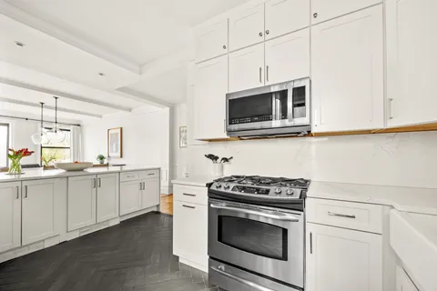 a kitchen with granite countertop cabinets stainless steel appliances and wooden floor