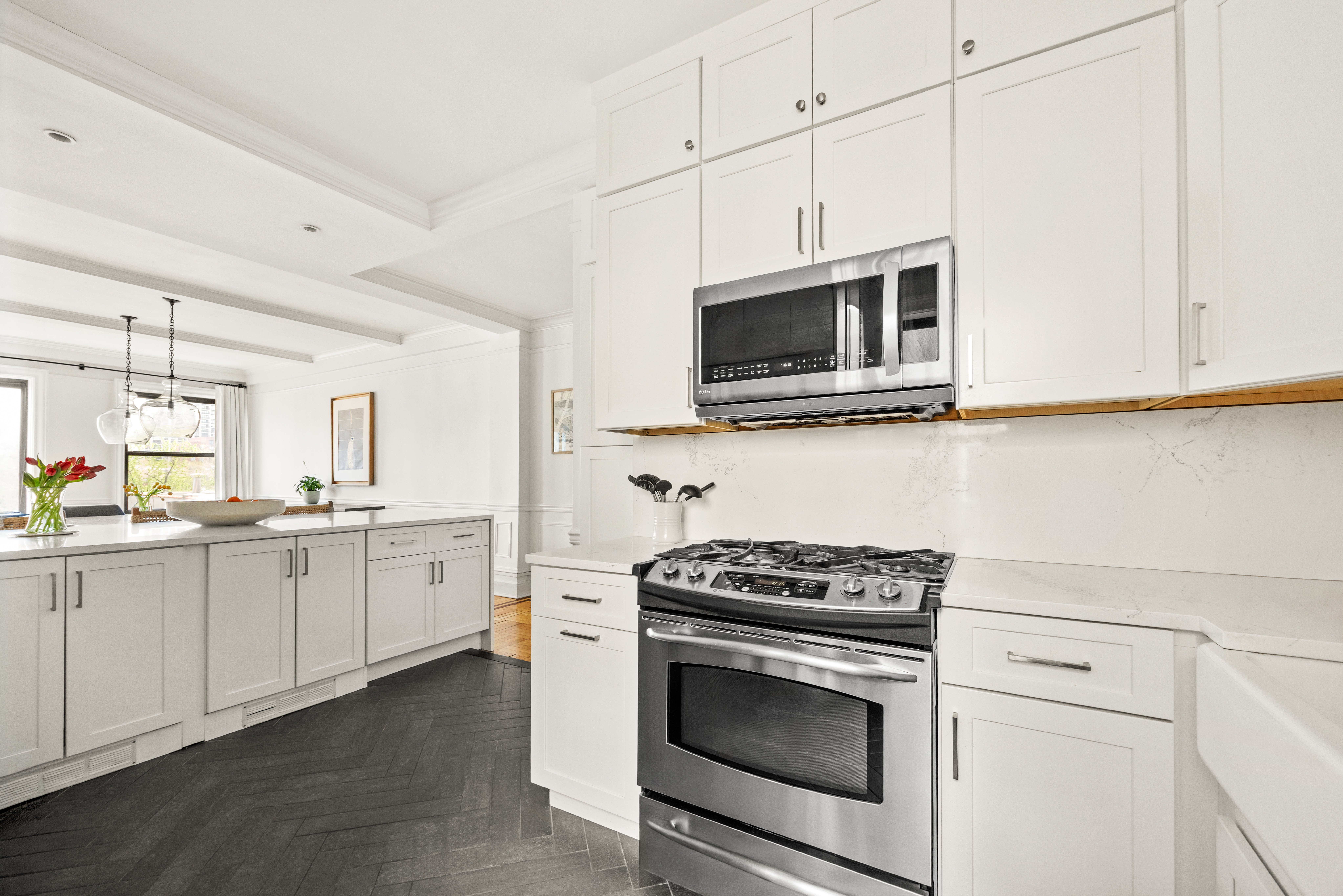 150 West 87th Street, Unit 7C Manhattan, NY 10024 - Photo 7 of 18 a kitchen with granite countertop cabinets stainless steel appliances and wooden floor