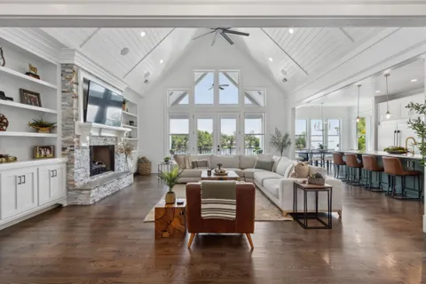 a living room with furniture a fireplace and a large window