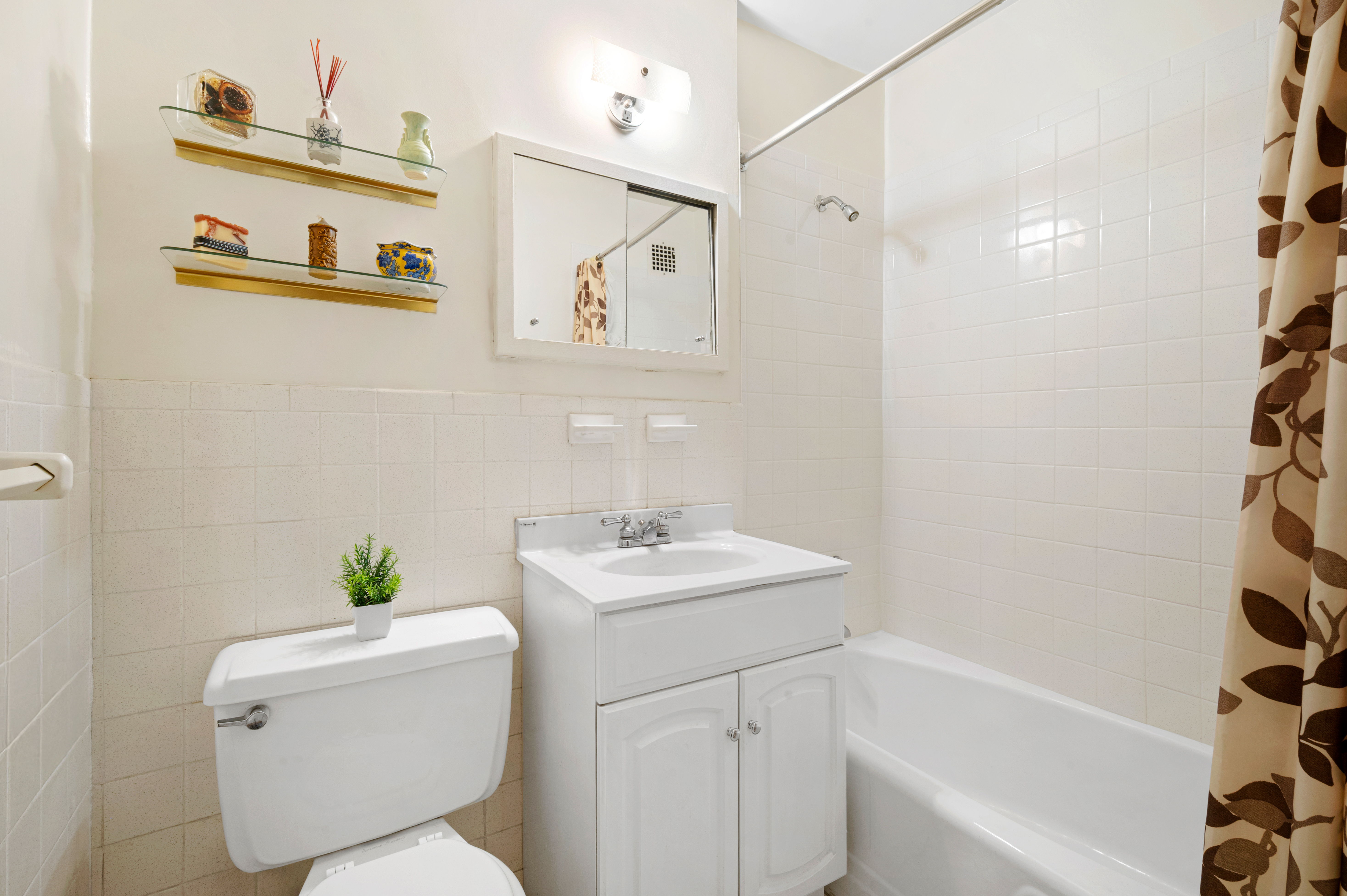 165 West 66th Street, Unit 2R Manhattan, NY 10023 - Photo 4 of 6 a bathroom with a sink toilet and shower
