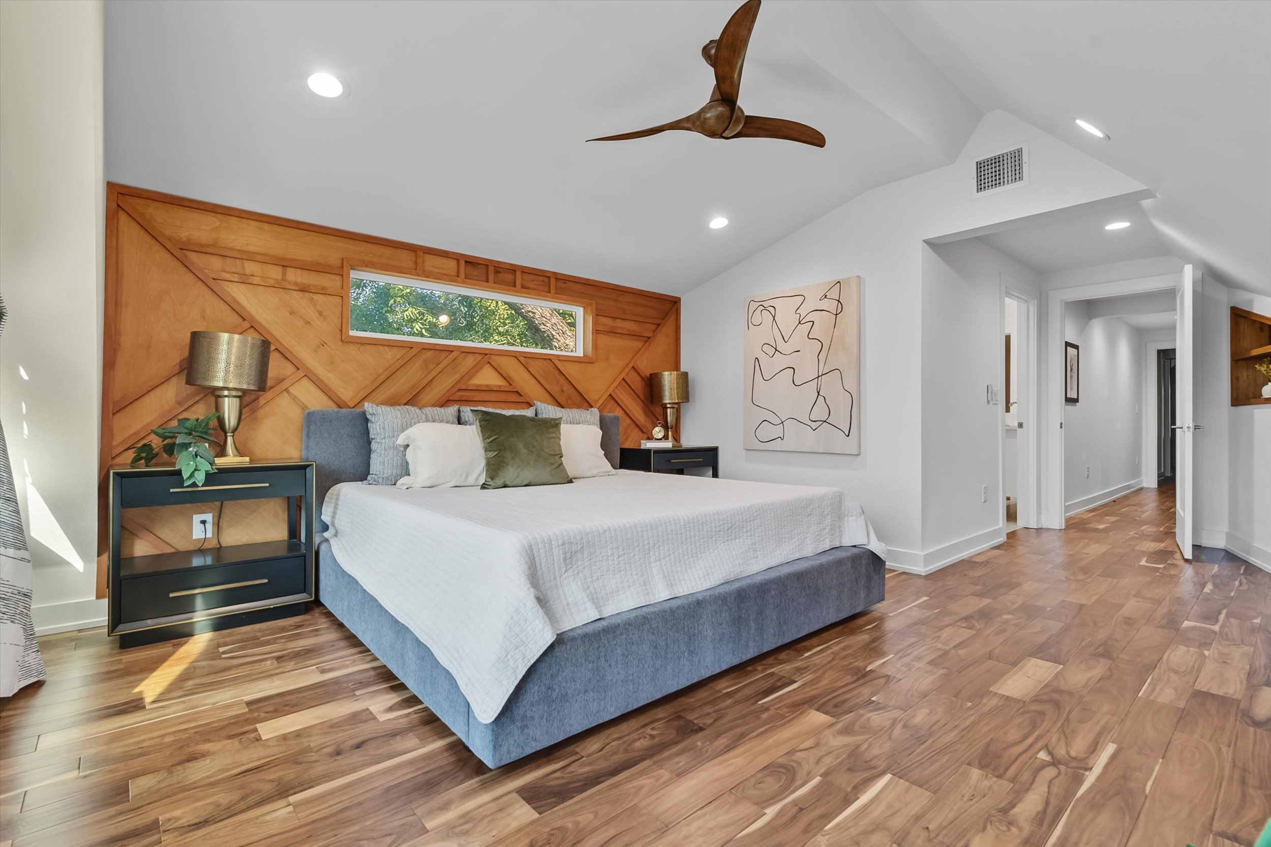 2712 Oak Springs Drive, Unit A Austin, TX 78702 - Photo 6 of 26 a bedroom with a large bed and a chandelier