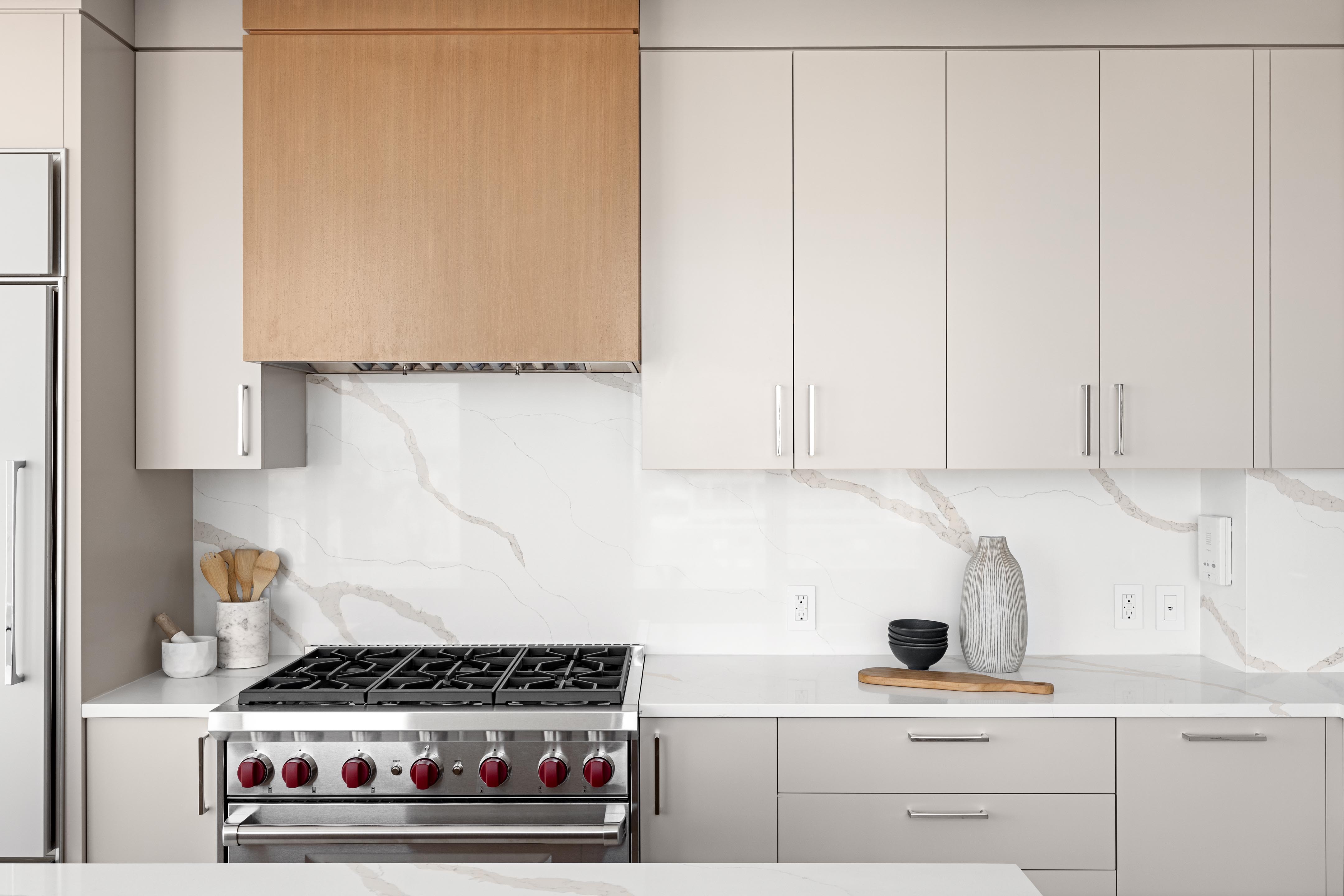 422 East 72nd Street, Unit 37AD Manhattan, NY 10021 - Photo 10 of 38 a kitchen with white cabinets and appliances