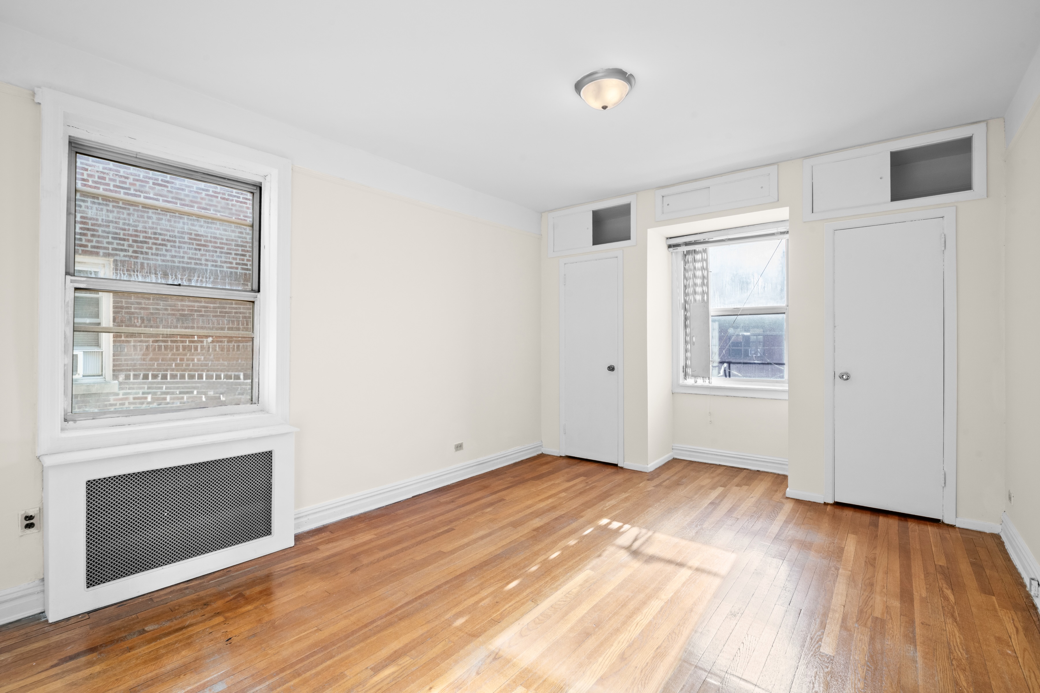 40 Tehama Street, Unit 6E Brooklyn, NY 11218 - Photo 5 of 16 a view of empty room with wooden floor and fireplace