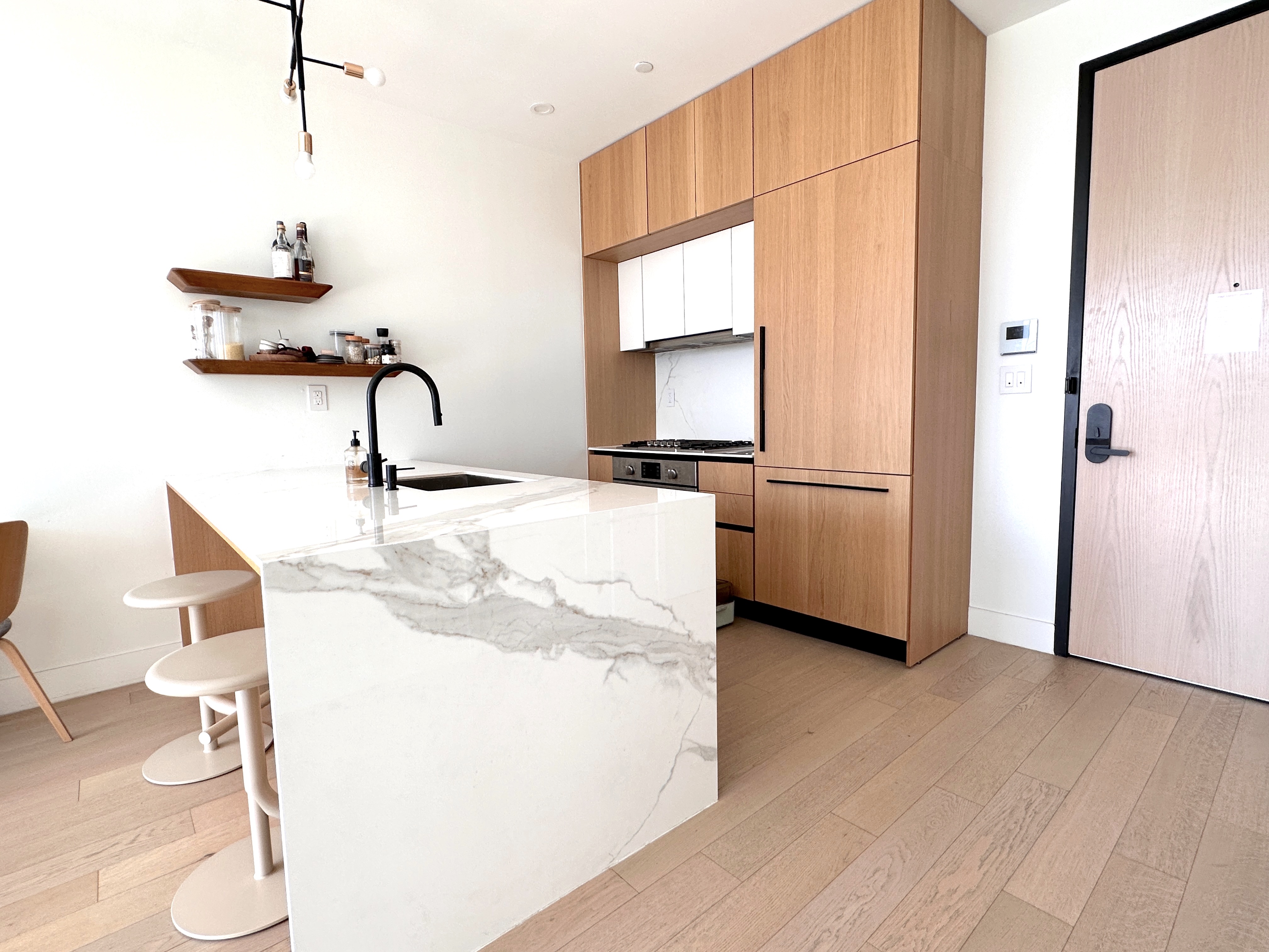 4507 Court Square West, Unit 10E Queens, NY 11101 - Photo 3 of 14 a kitchen with a refrigerator and a sink