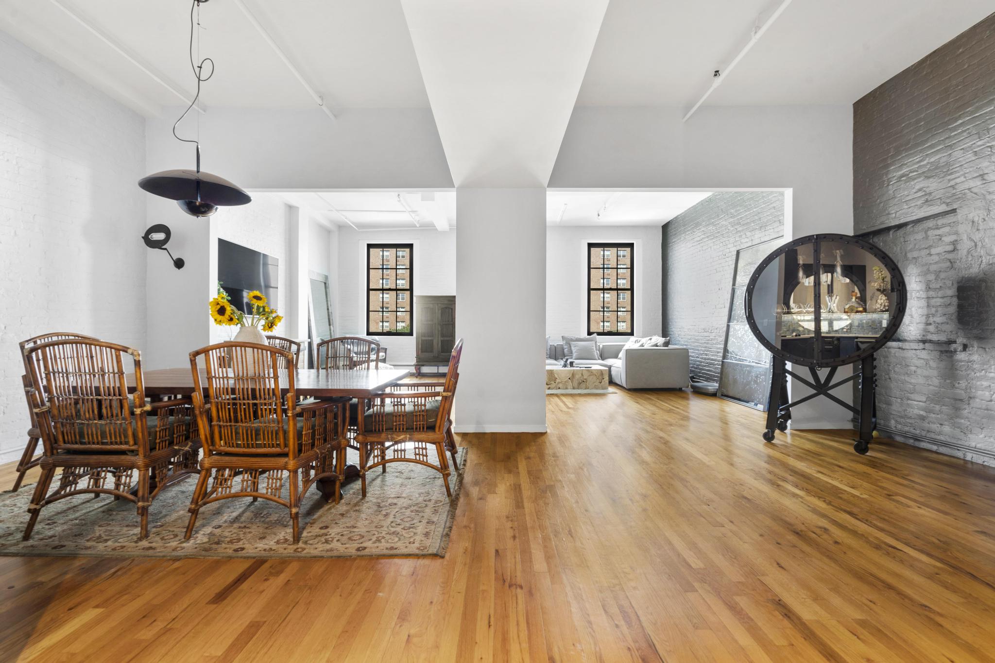 363 Greenwich Street, Unit 3C Manhattan, NY 10013 - Photo 2 of 11 a living room with furniture a dining table and wooden floor