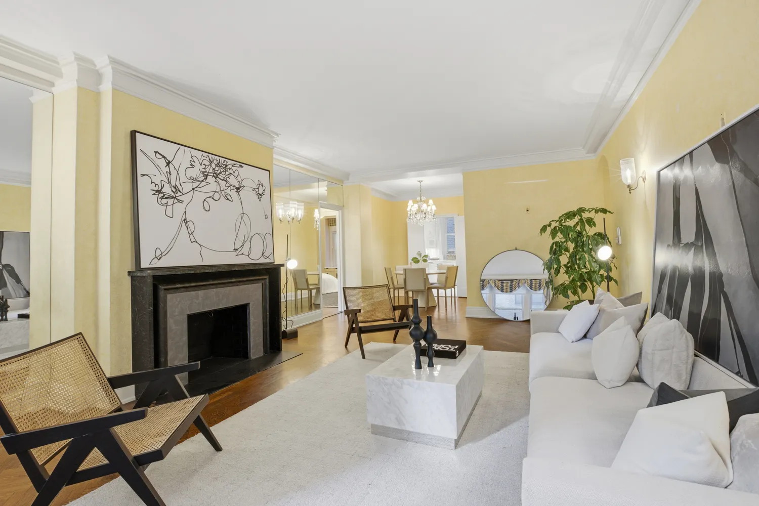 a living room with furniture a fireplace and a potted plant