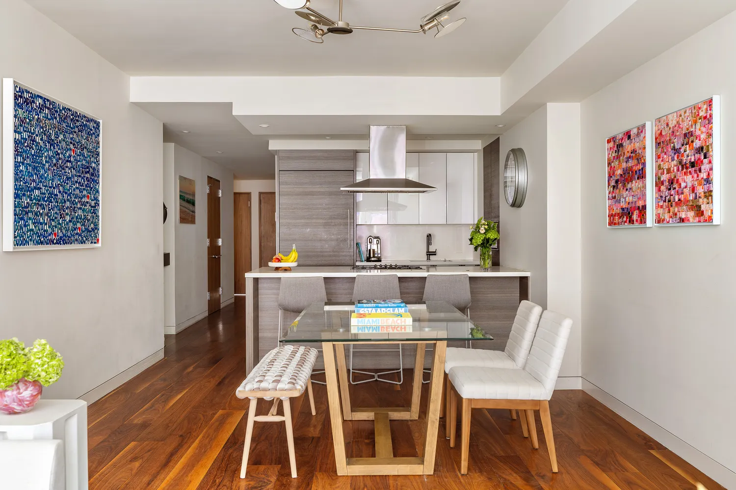 a view of a dining room with furniture wooden floor and a chandelier