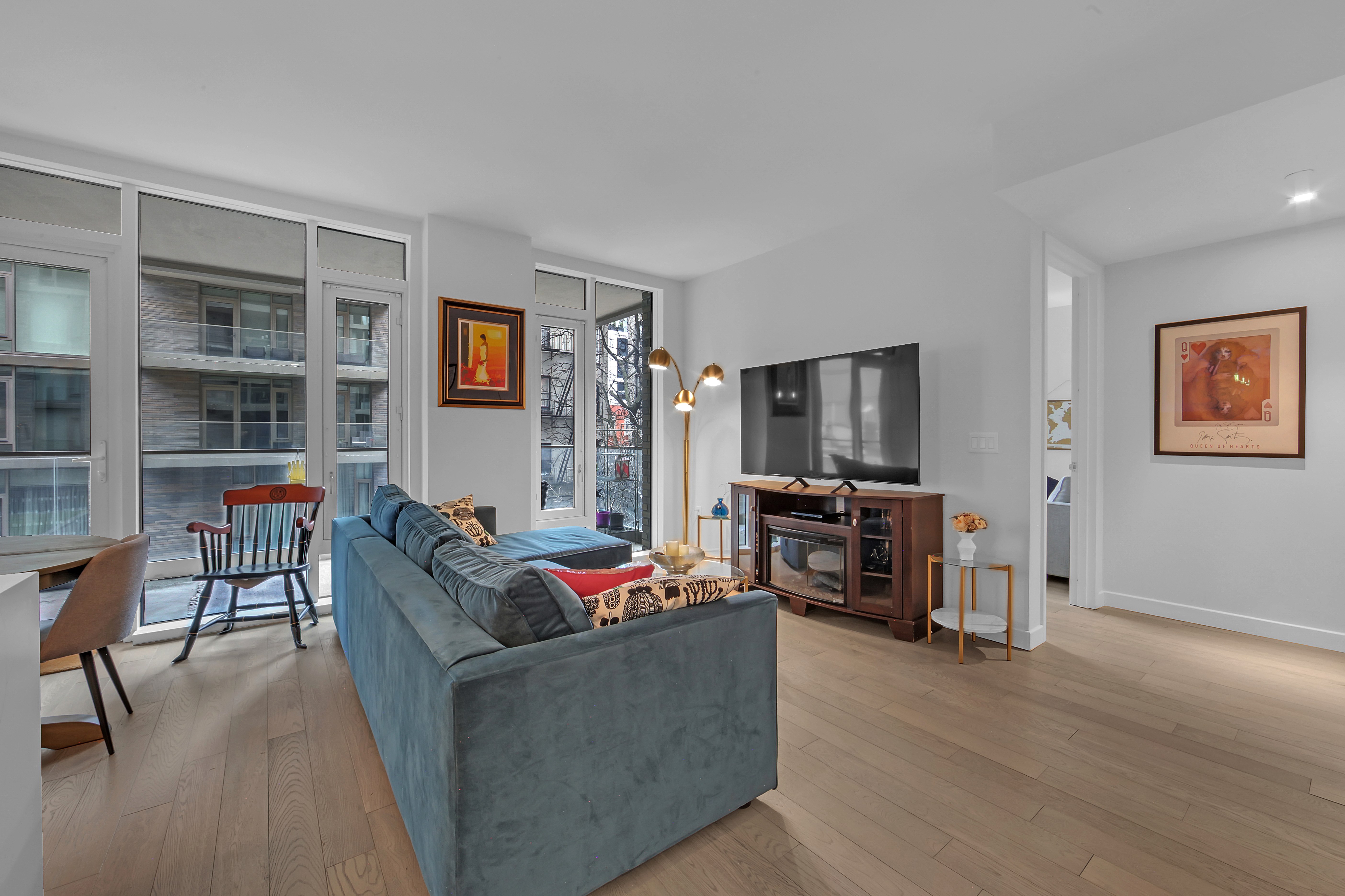 505-513 West 43rd Street, Unit 3M Manhattan, NY 10036 - Photo 7 of 20 a living room with furniture and a flat screen tv