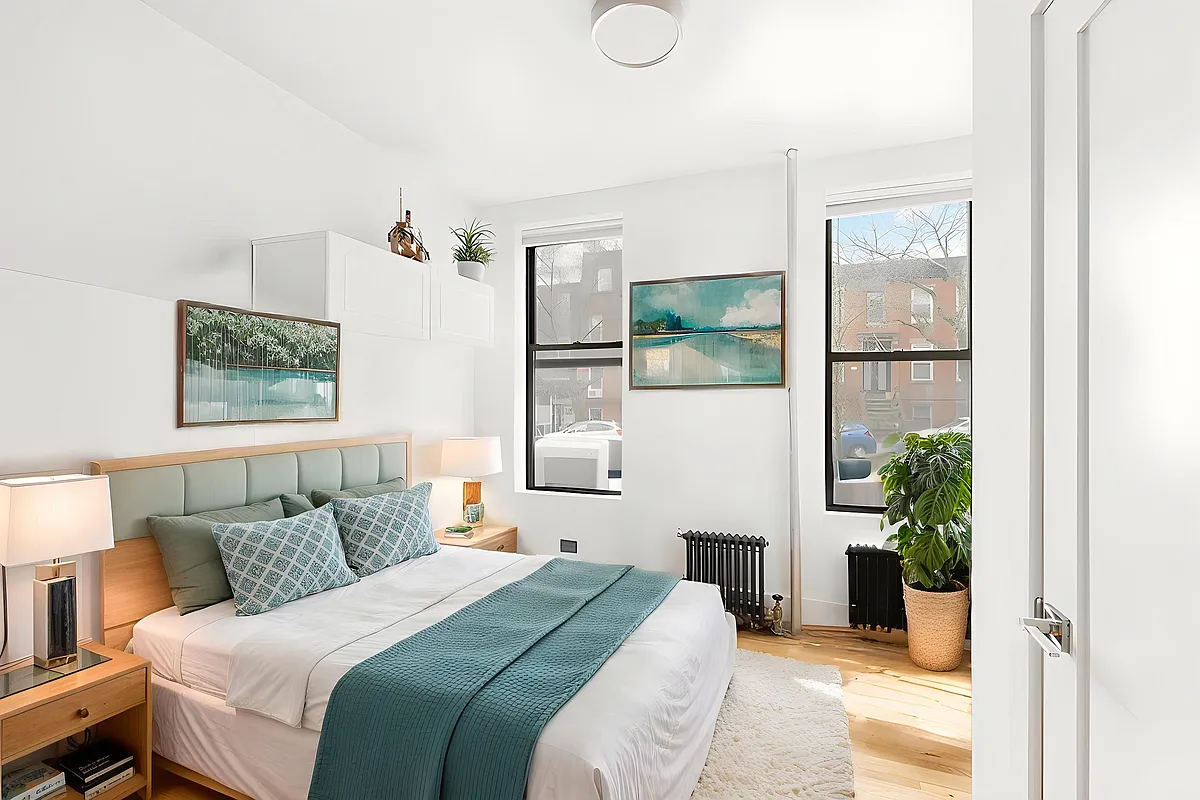 53 3rd Street, Unit 1R Brooklyn, NY 11231 - Photo 4 of 6 a bedroom with a balcony a bed and a potted plant