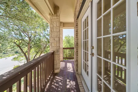 a view of balcony with wooden floor and fence