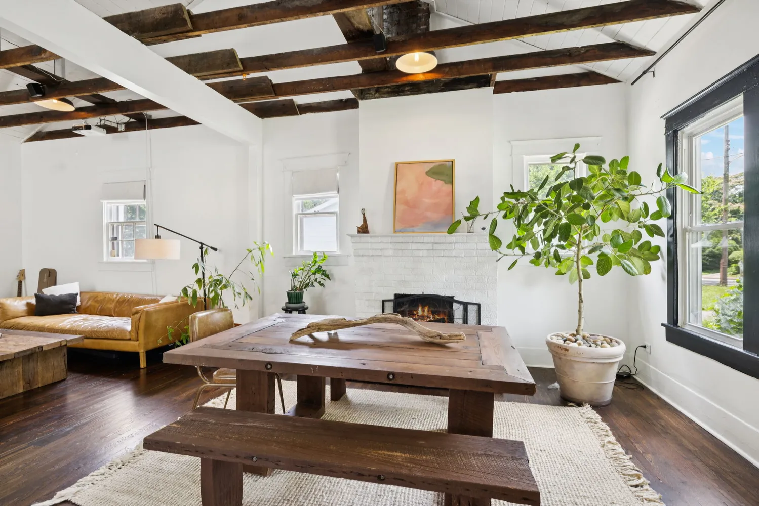 a view of a livingroom with furniture and a potted plant