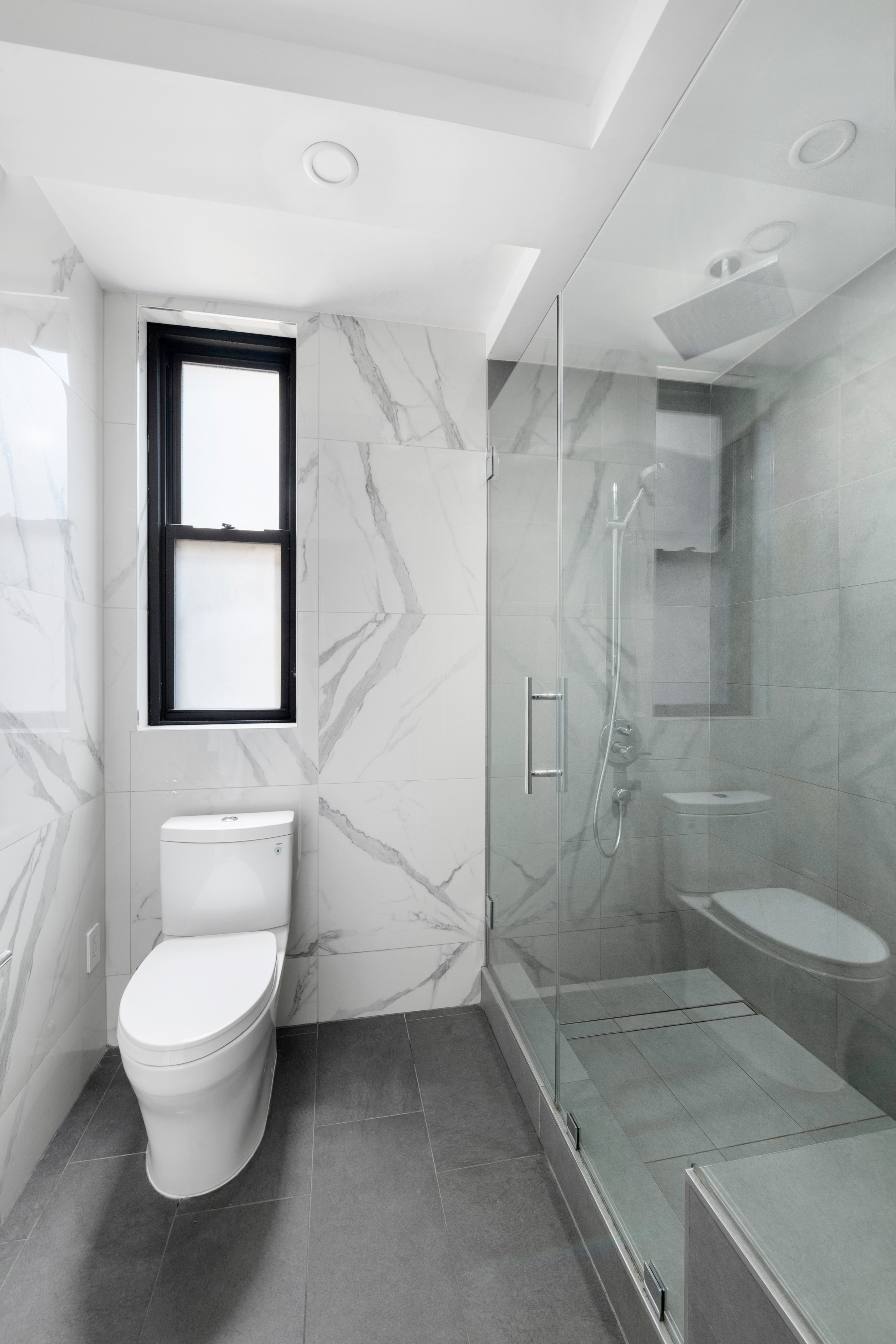 308 East 79th Street, Unit 13EF Manhattan, NY 10075 - Photo 8 of 16 a bathroom with a toilet sink and shower