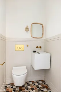 a bathroom with a sink mirror and toilet