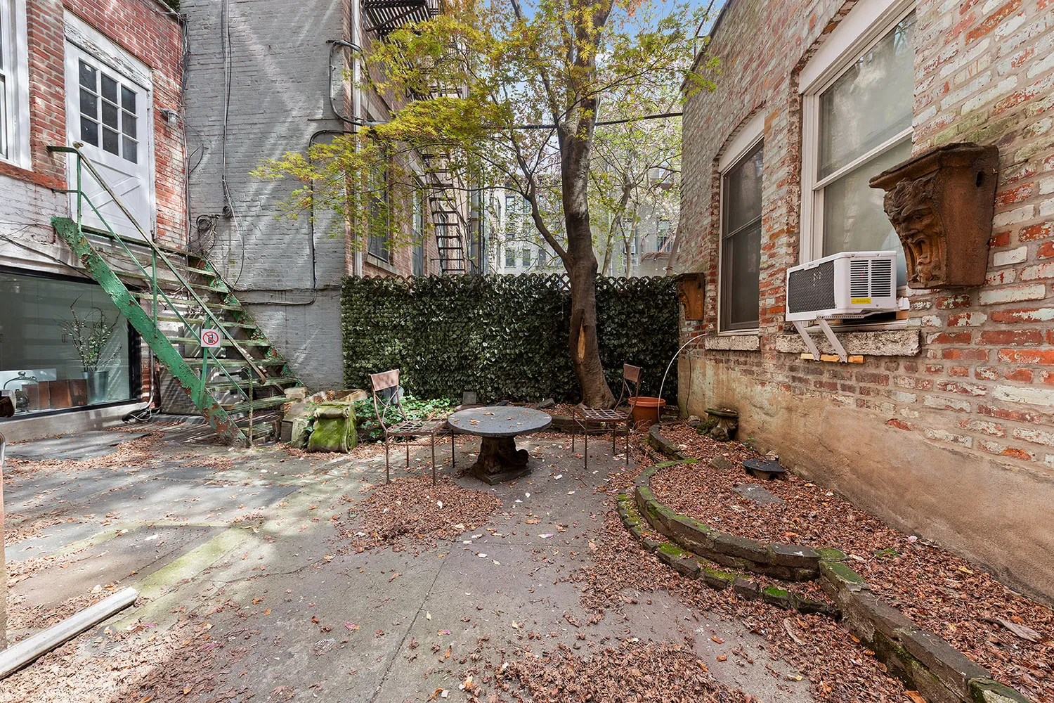 a view of a backyard with sitting area