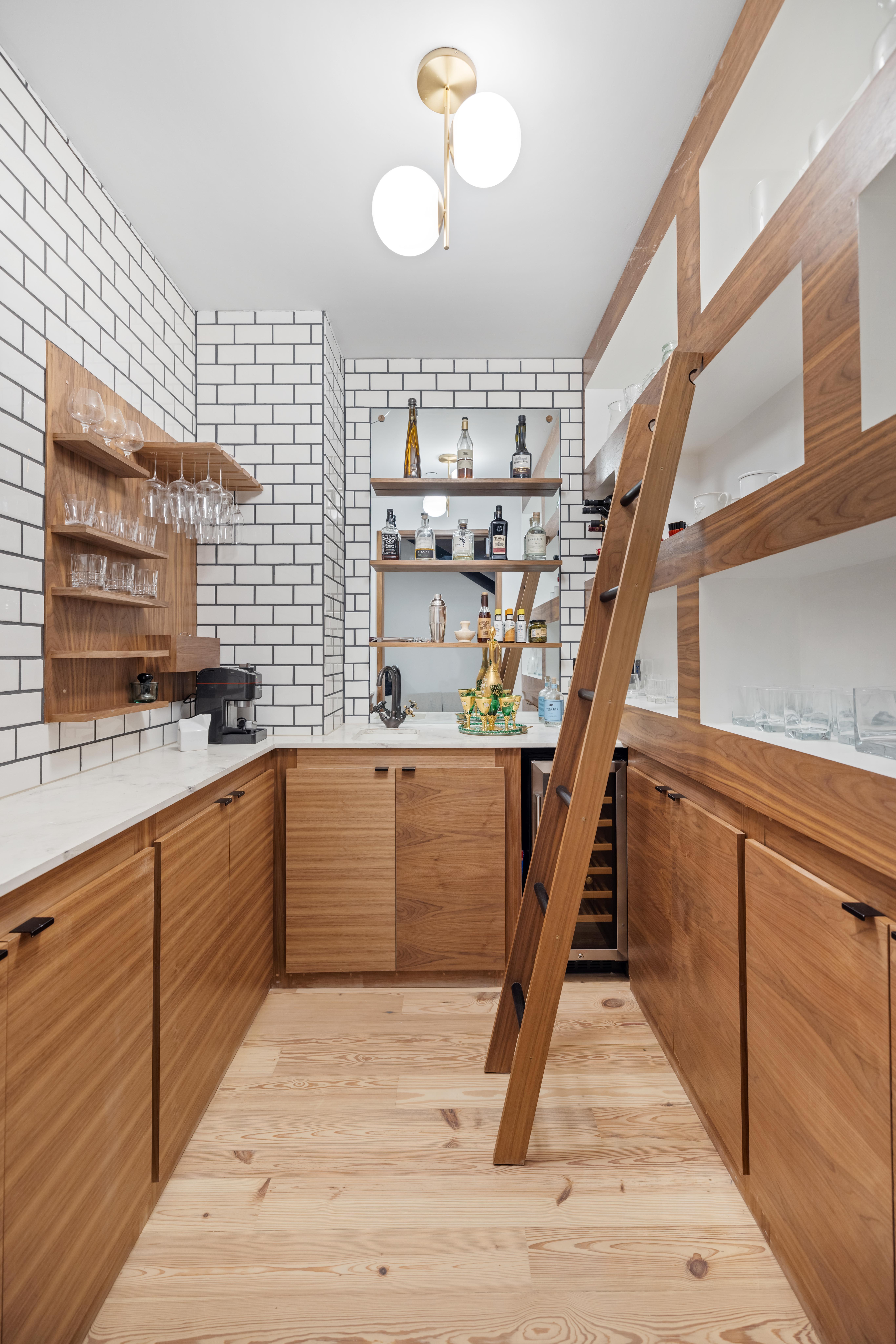 130 Furman Street, Unit S102 Brooklyn, NY 11201 - Photo 3 of 26 a kitchen with a wooden floor and cabinets