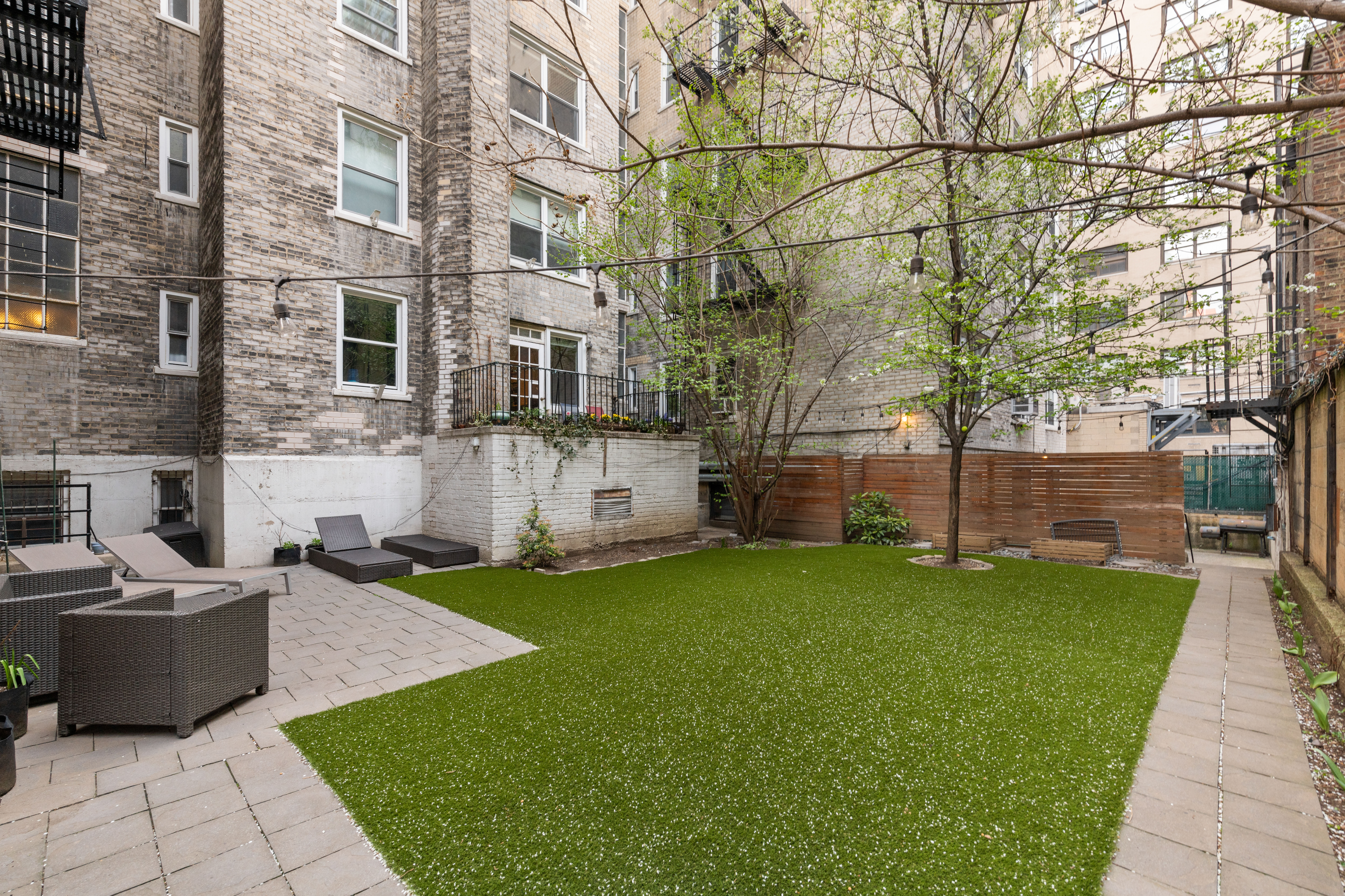 310 West 55th Street, Unit 5K Manhattan, NY 10019 - Photo 7 of 9 a view of a patio with a yard
