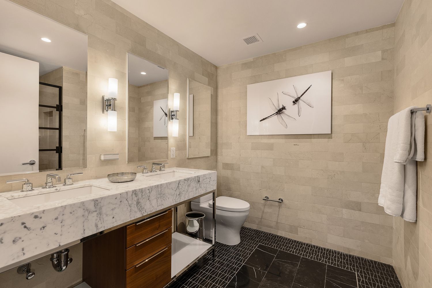 a bathroom with a granite countertop sink a toilet and a mirror