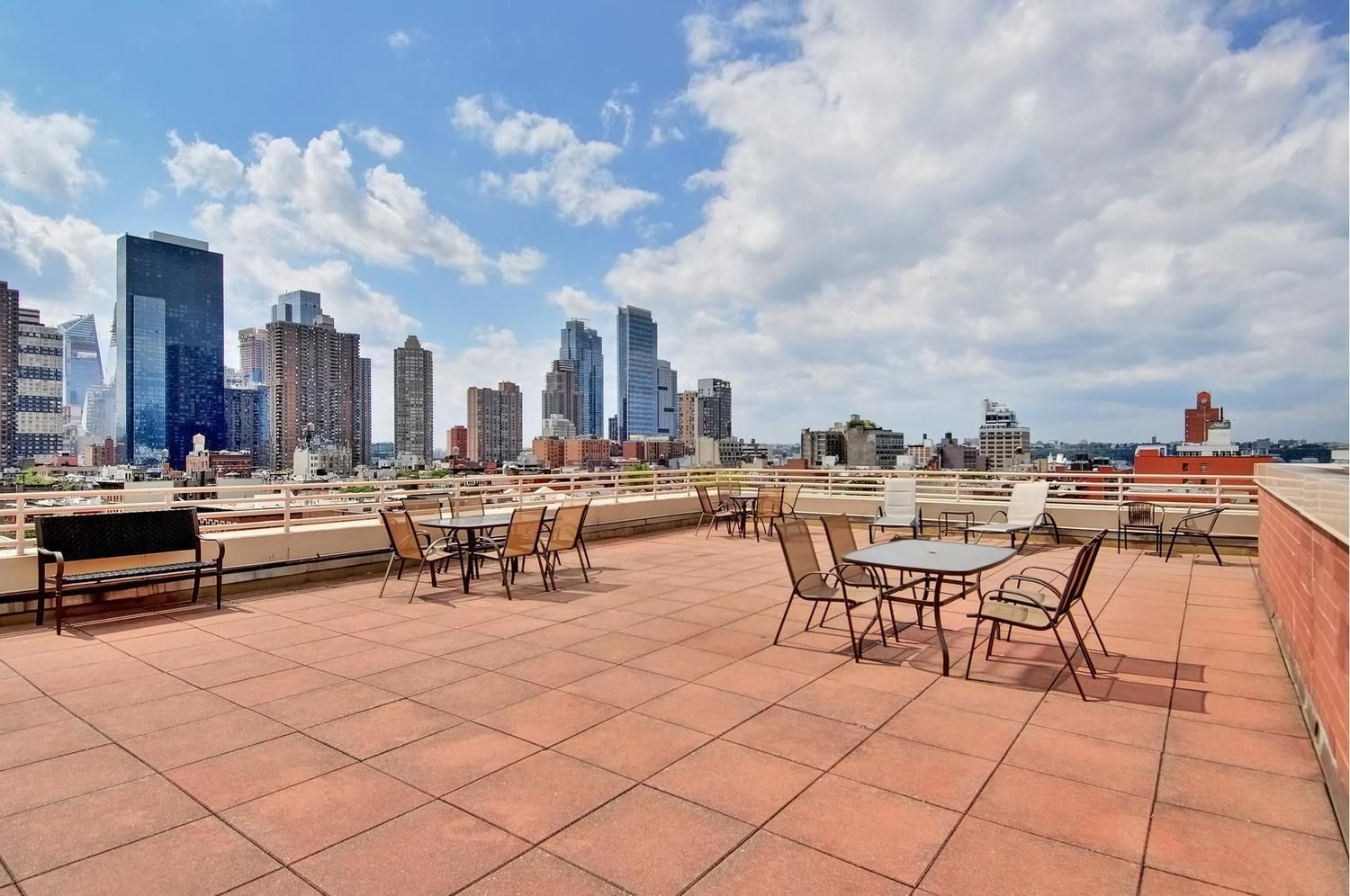 393 West 49th Street, Unit 6G Manhattan, NY 10019 - Photo 9 of 11 a view of a patio with dining table and chairs