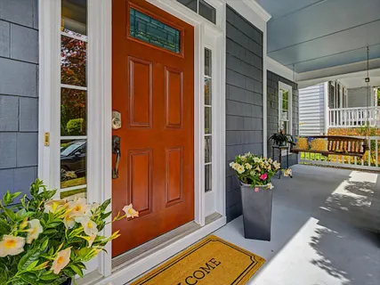 a view of a porch with furniture and floor to ceiling window