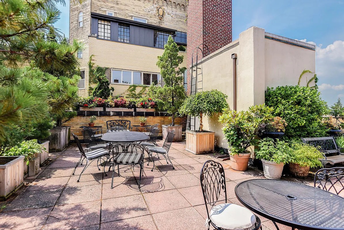 30 5th Avenue, Unit 6H Manhattan, NY 10011 - Photo 14 of 17 a view of a patio with table and chairs potted plants and large tree