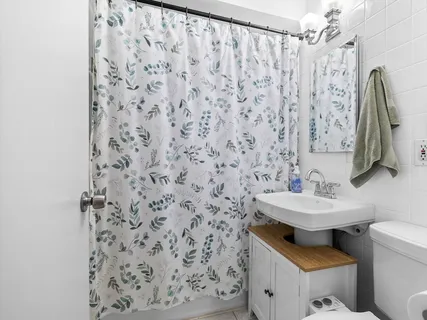 a bathroom with a sink toilet and a mirror