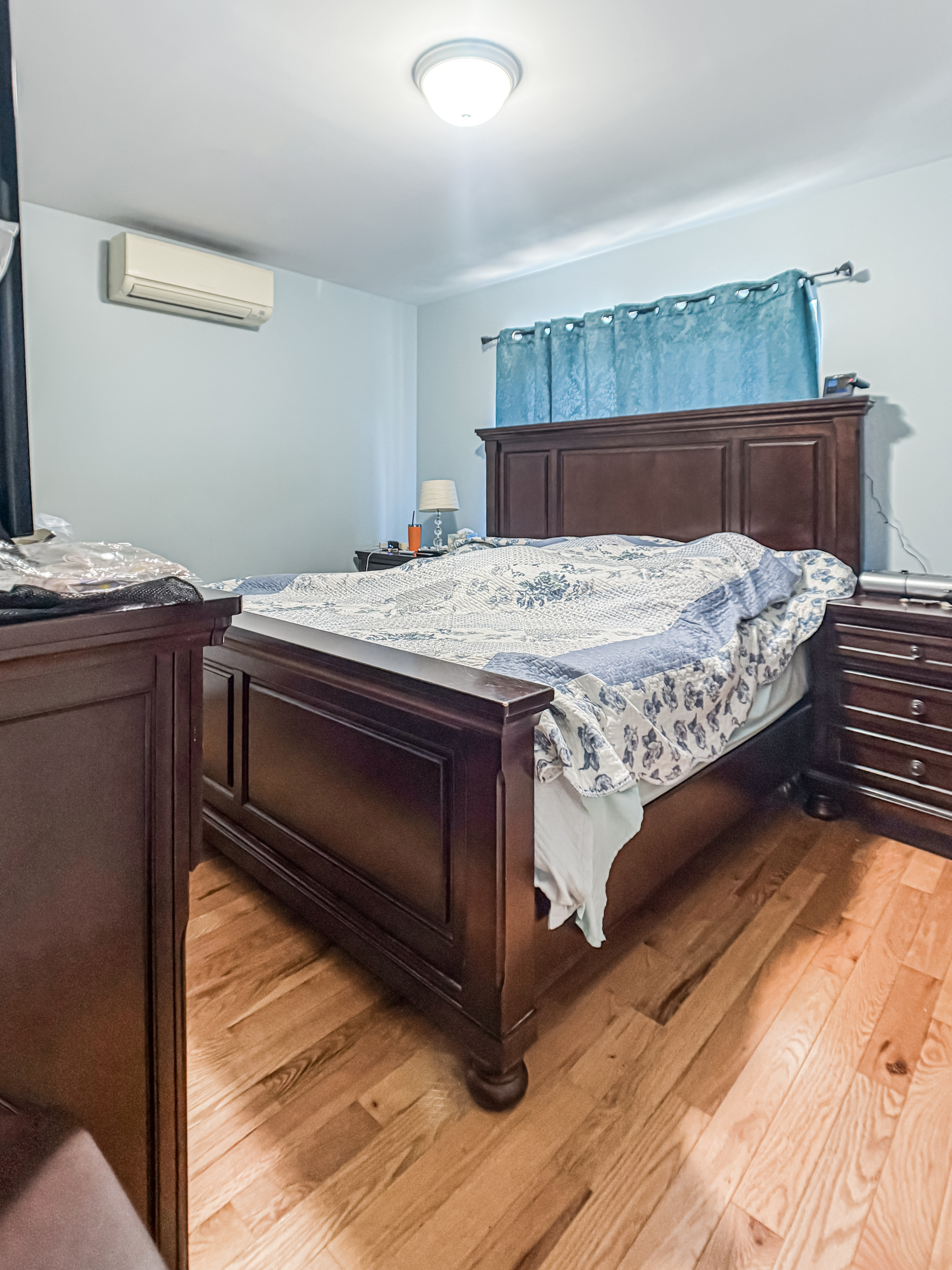 3827 28th Street Queens, NY 11101 - Photo 12 of 13 a bedroom with a bed and a dresser