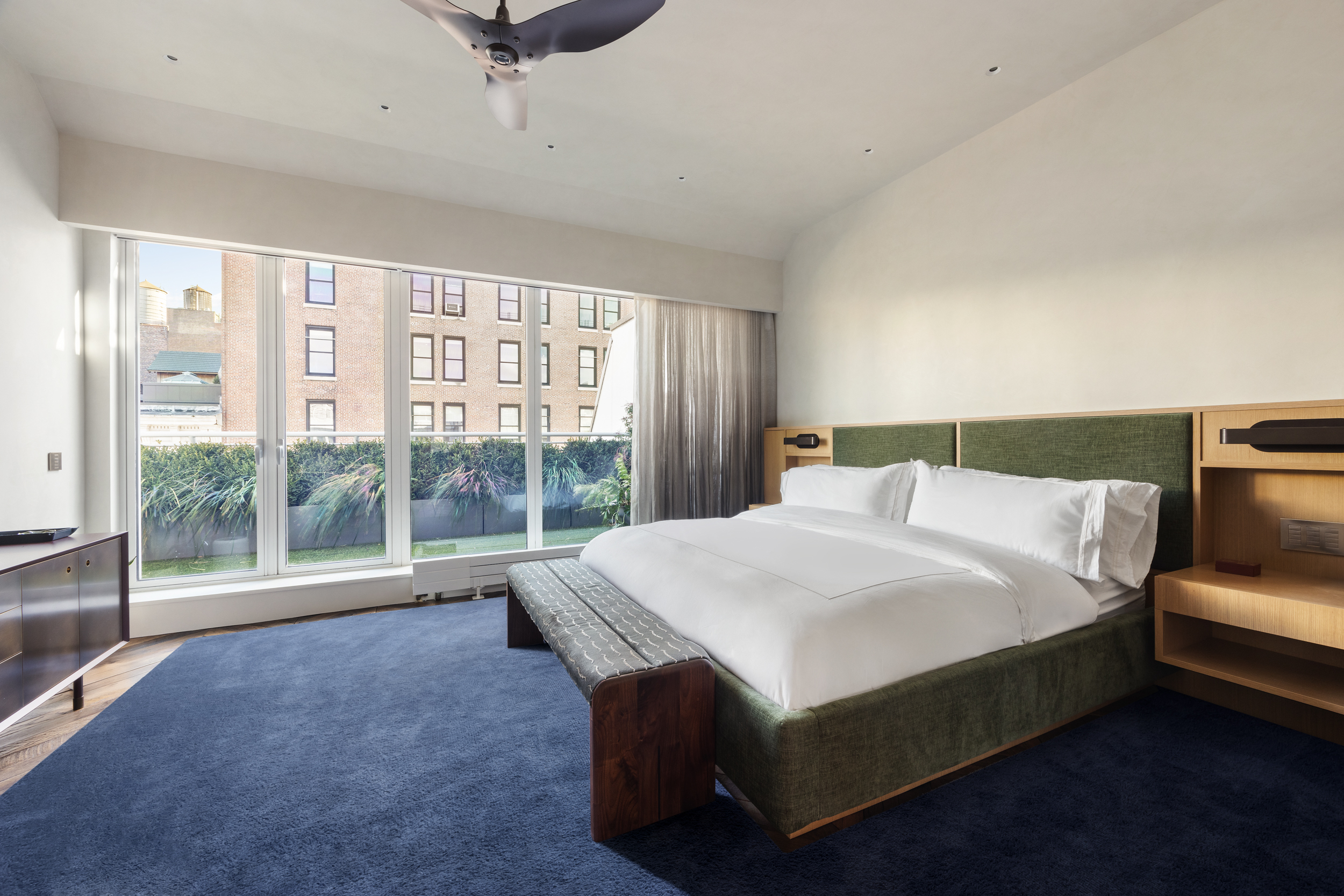 109 Greene Street, Unit PH6A Manhattan, NY 10012 - Photo 9 of 26 a bed sitting in a bedroom next to a large window