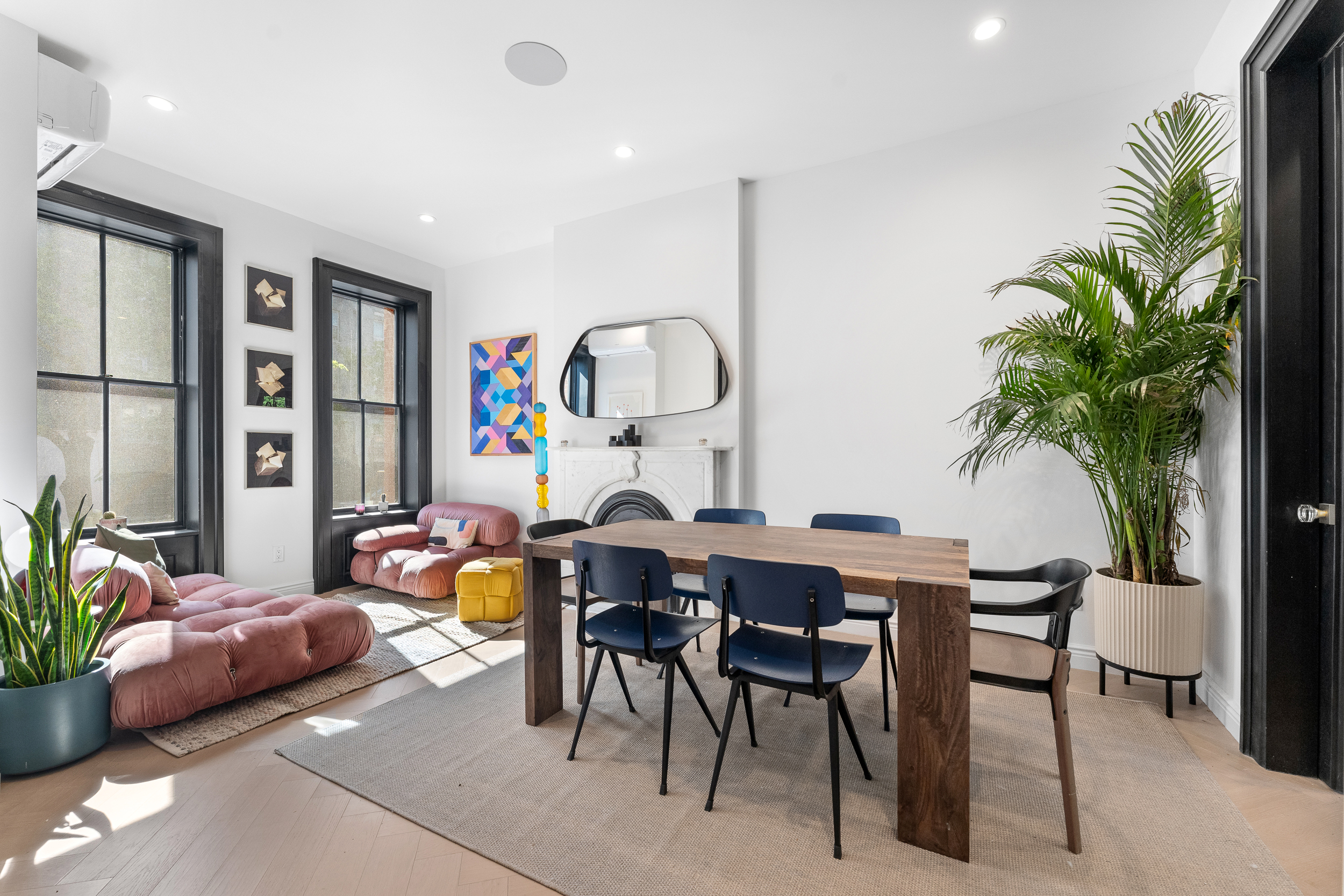 a living room with furniture and a potted plant