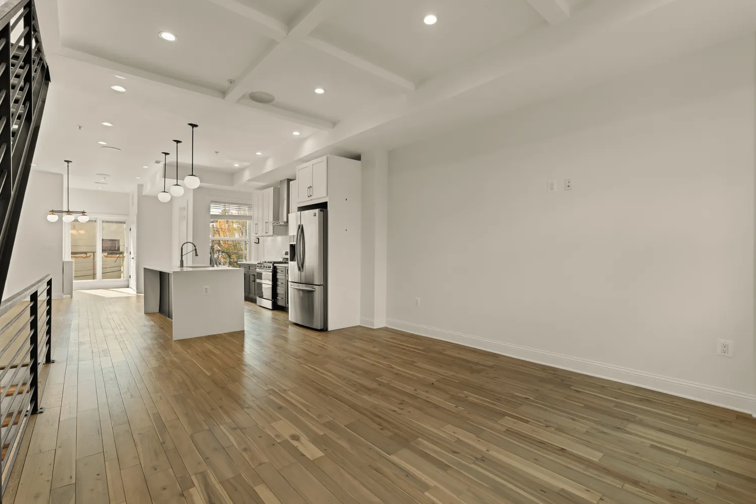 a view of a kitchen with wooden floor and a window