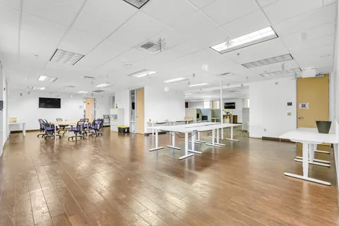 a view of empty room with wooden floor and living room
