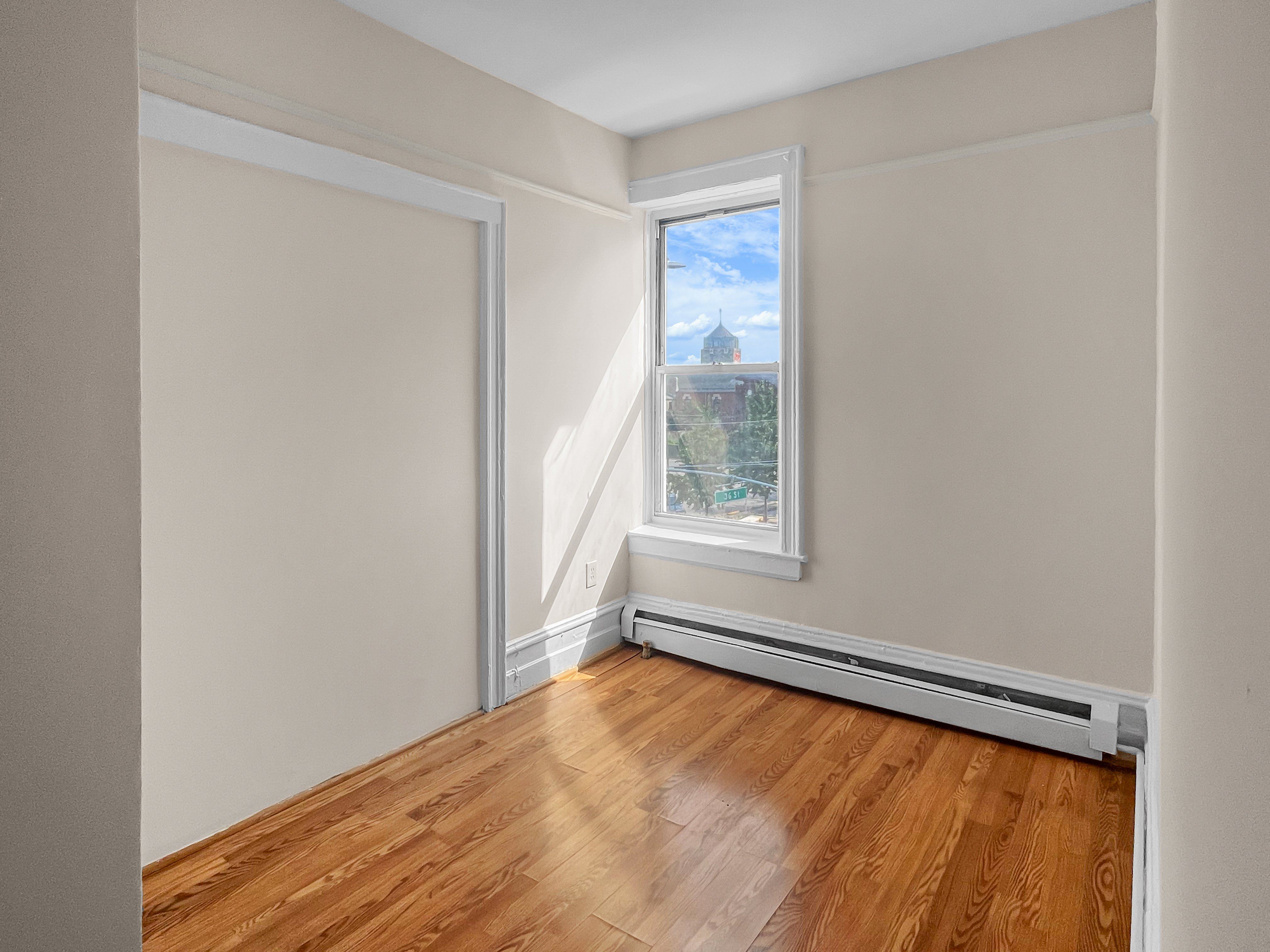 35-19 Broadway, Unit 3 Queens, NY 11106 - Photo 7 of 11 an empty room with windows