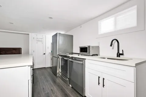 a kitchen with stainless steel appliances a refrigerator stove and sink