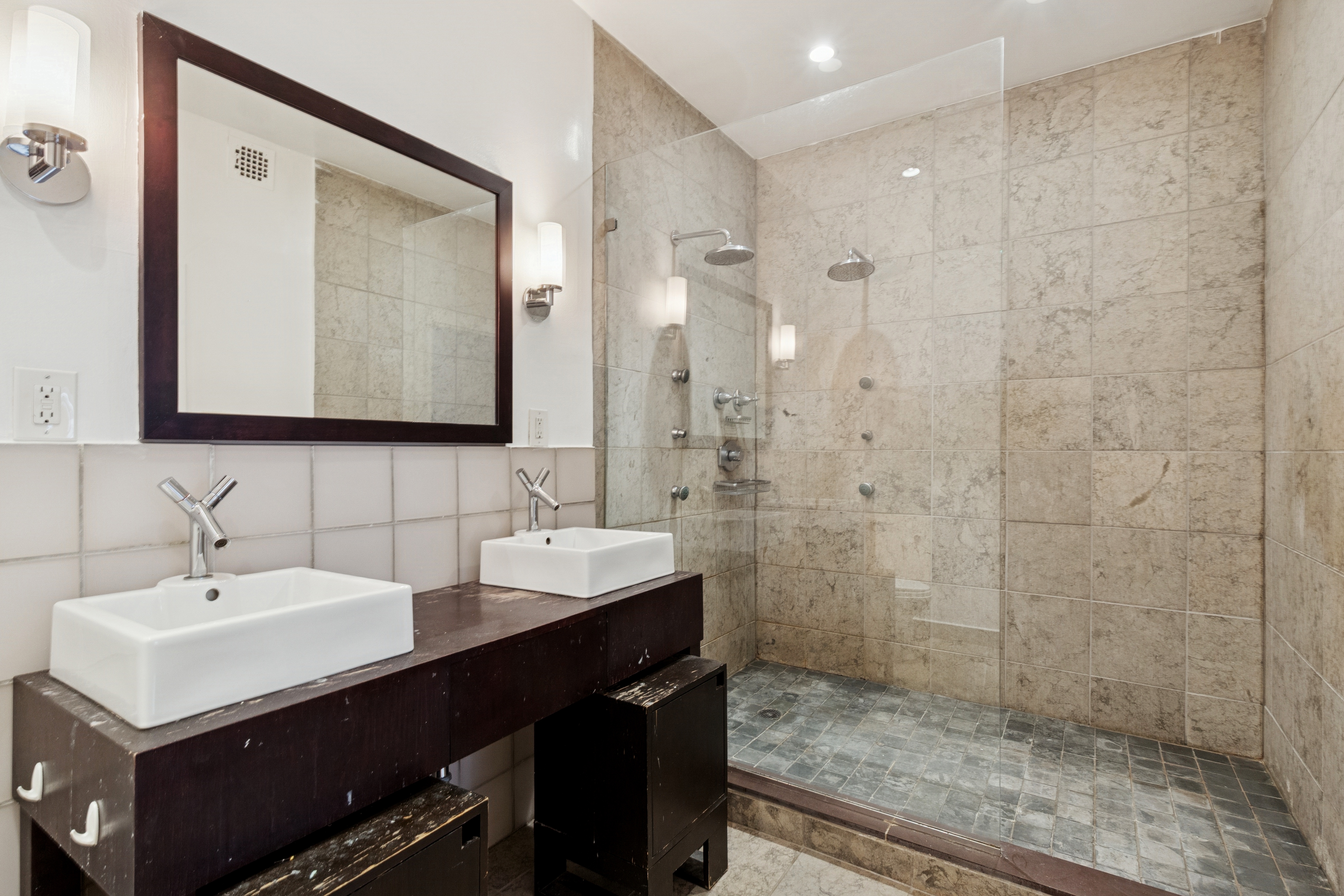 136-140 West 23rd Street, Unit 4CC Manhattan, NY 10011 - Photo 10 of 13 a bathroom with a sink and a mirror