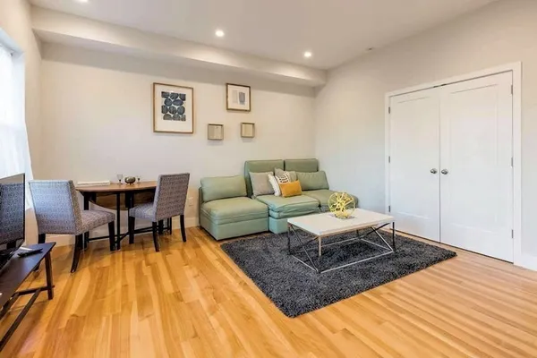 a living room with a couch and a rug