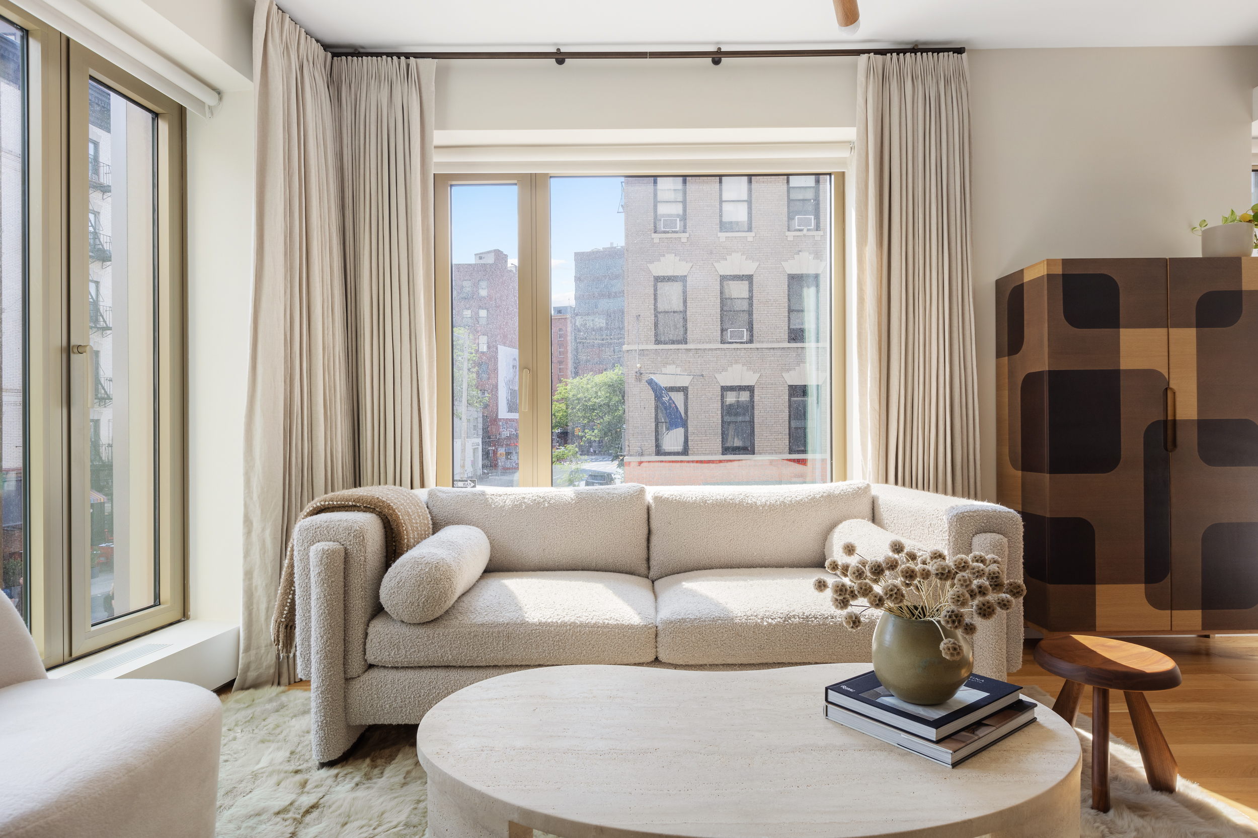 75 Kenmare Street, Unit 2D Manhattan, NY 10012 - Photo 3 of 15 a living room with furniture and a large window