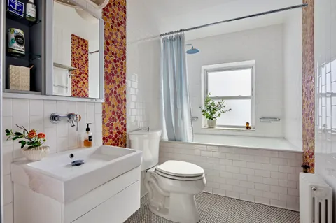 a bathroom with a sink a mirror and a toilet