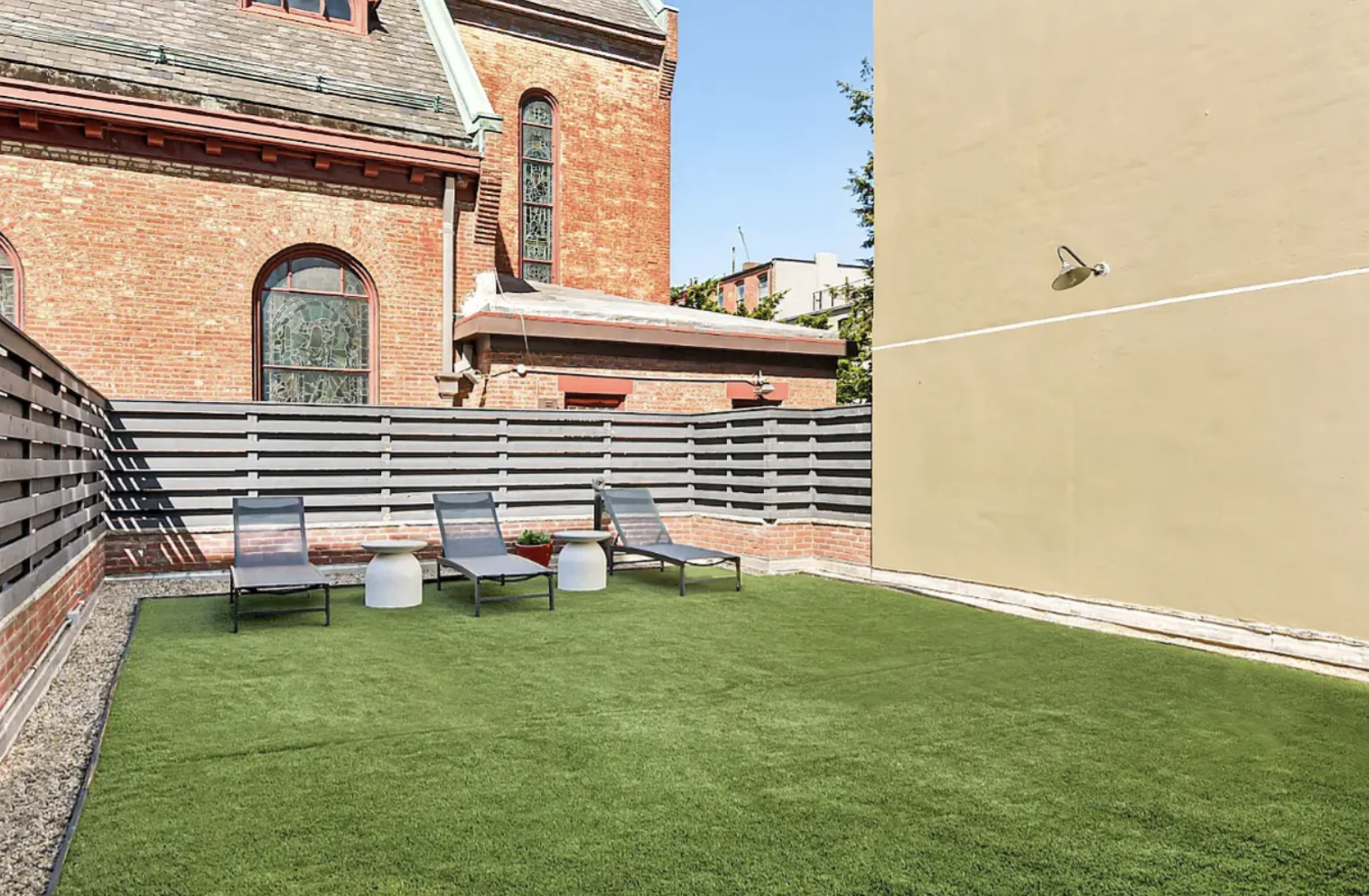 180 Bainbridge Street, Unit 304 Brooklyn, NY 11233 - Photo 8 of 21 a front view of a house with a garden