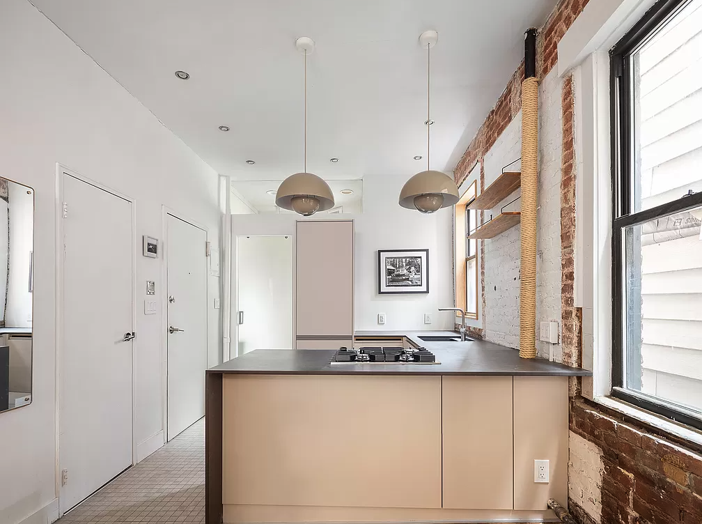 32 Jones Street, Unit 2A Manhattan, NY 10014 - Photo 4 of 7 a bathroom with granite countertop a large window and a glass door