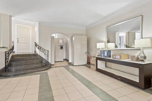 a front view of a building with garden and flowers