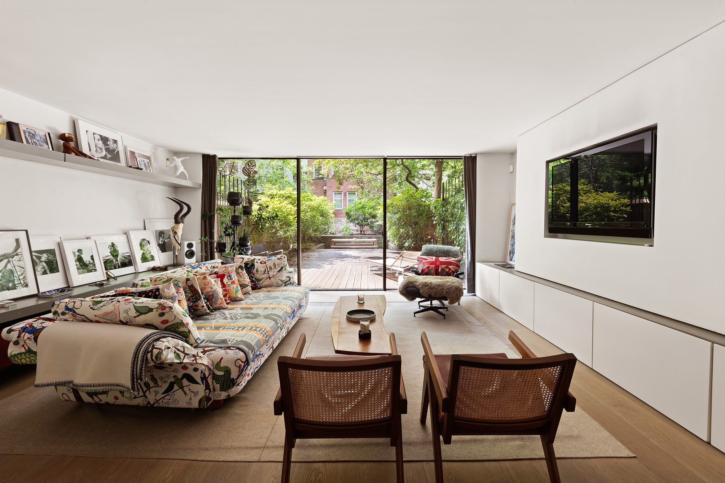456 West 25th Street Manhattan, NY 10001 - Photo 2 of 22 a living room with furniture and a flat screen tv