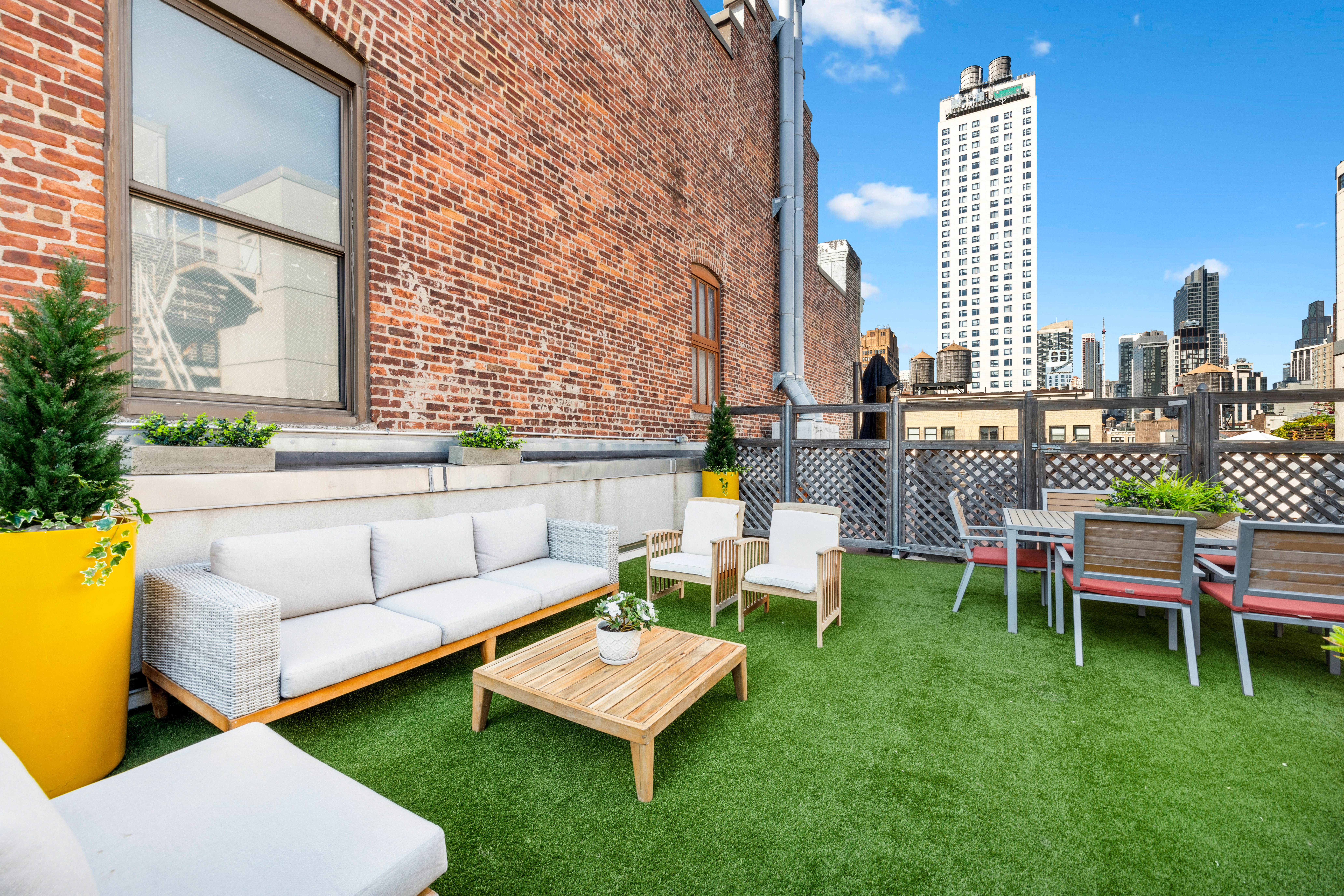 146-148 West 22nd Street, Unit PH Manhattan, NY 10011 - Photo 10 of 13 a view of a patio with couches and a table and chairs