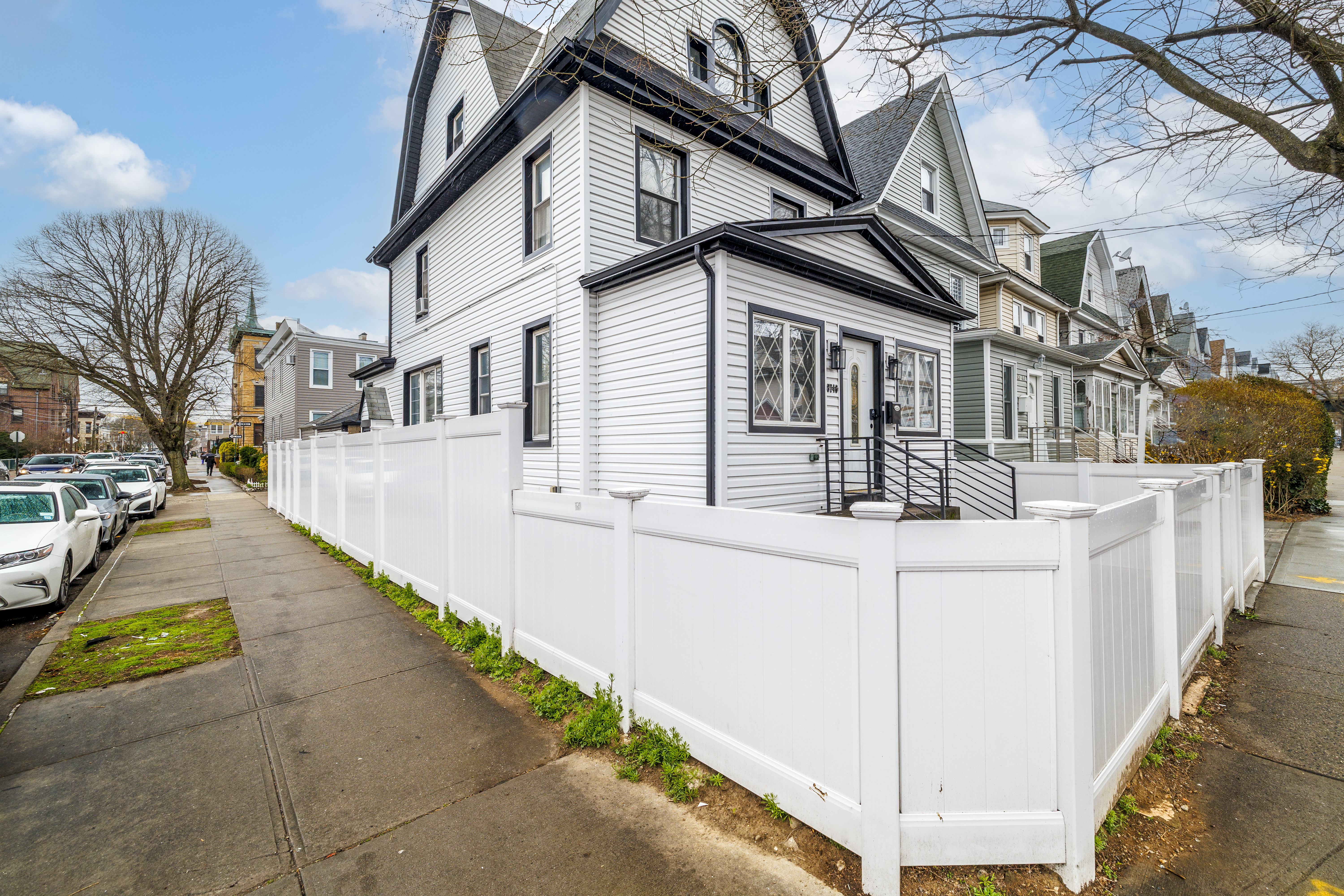 87-46 89th Street Queens, NY 11421 - Photo 16 of 25 a view of a white house with iron fence