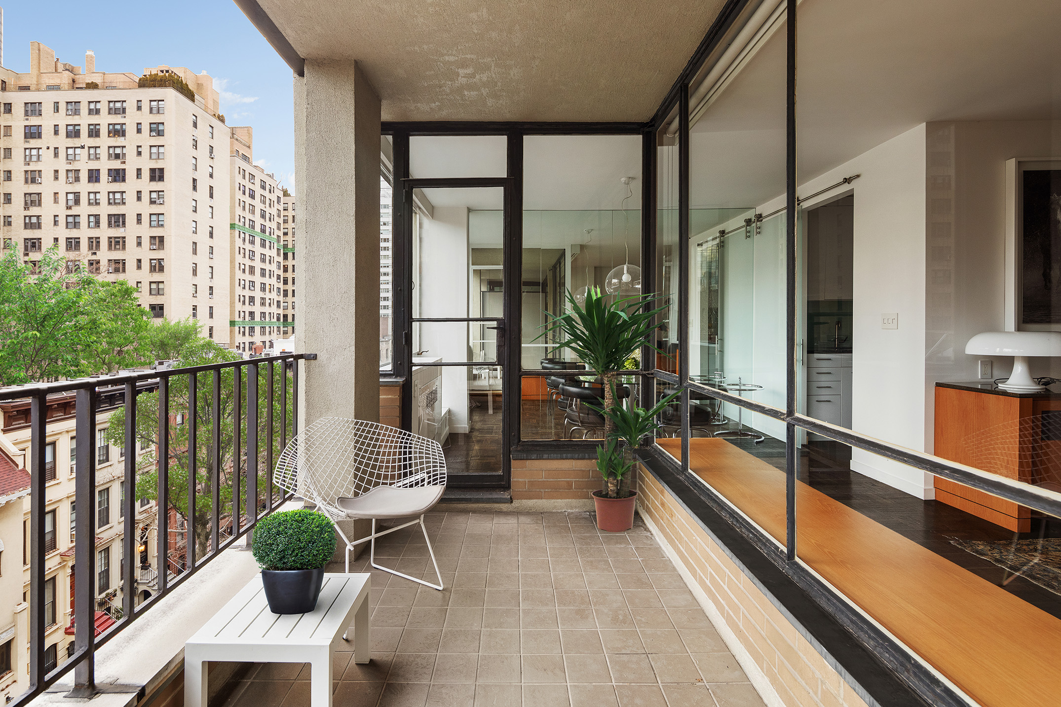 333 East 69th Street, Unit 7F Manhattan, NY 10021 - Photo 2 of 12 a balcony with chairs and a potted plant