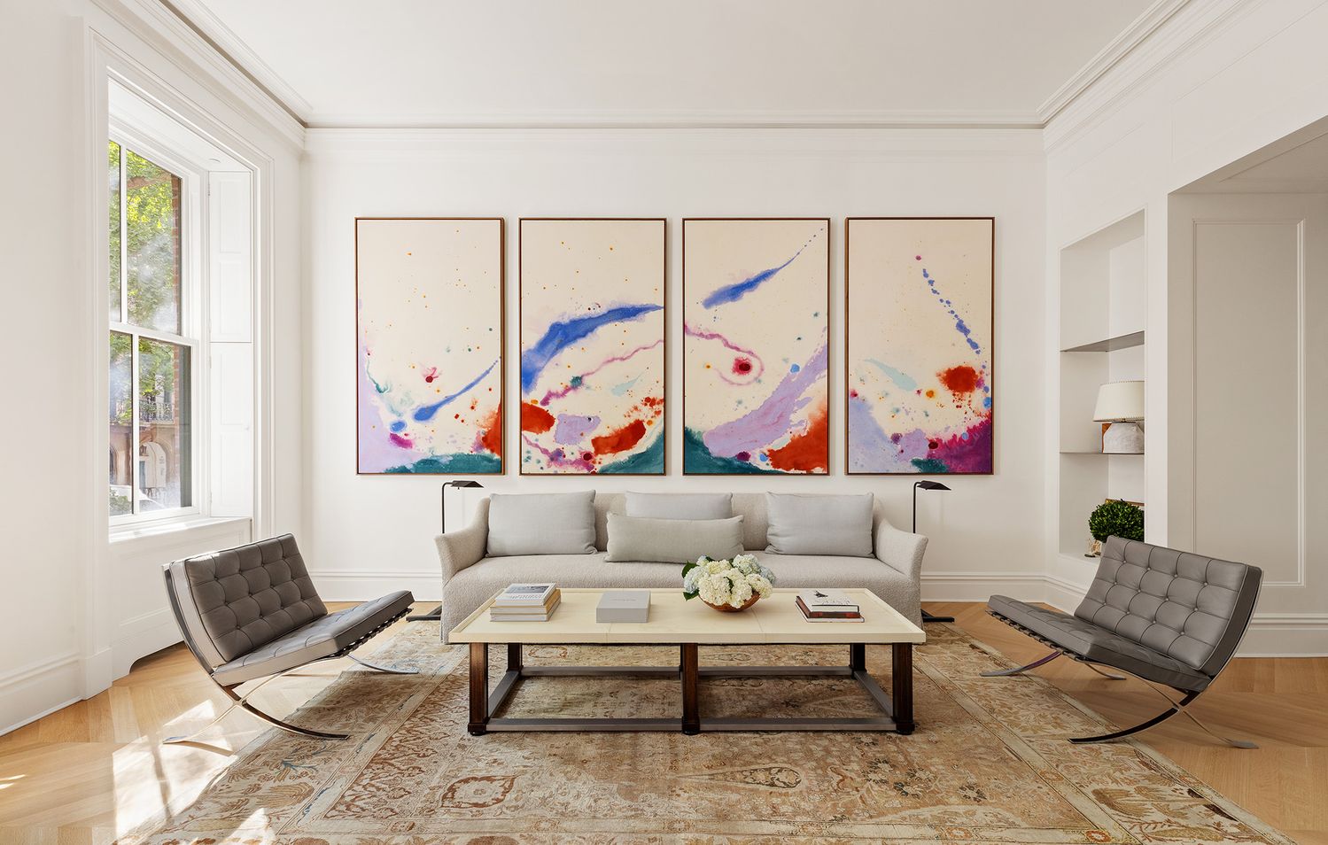 a living room with furniture and painting on the wall